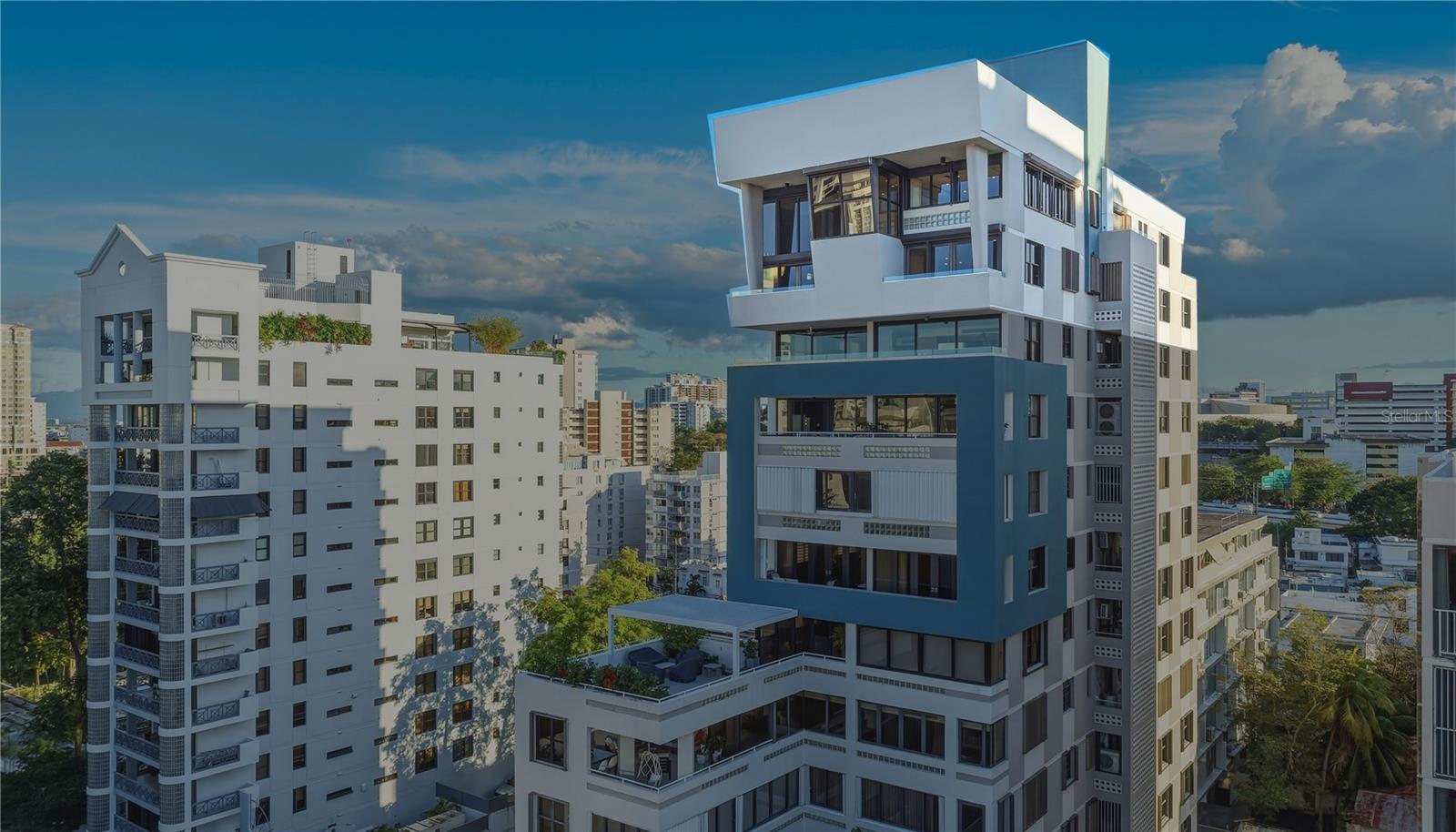 Experience the best of what CoBe offers; living within a short distance from the beach, restaurants and dynamic lifestyle. Spanning 5,295 total Sq. Ft. of meticulously designed space with keyed elevator entry, this two-story penthouse combines architectural intention with the unmatched vibrancy of one of San Juan's most coveted districts. Attention to detail and custom finishes can be seen throughout the PH’s two-level layout with ceiling heights of up to 16’9’’, accented by multiple alfresco spaces with city and water views. On the first level, you are greeted by a double-height living room with Baccarat crystal chandelier and den with wet bar, in addition to an exceptionally large eat-in kitchen with dining area. The east wing on this floor houses all three guest bedrooms and three full bathrooms. The primary suite is situated on the second floor, serving as an enviable retreat with an oversized walk-in closet and spacious terrace with Jacuzzi overlooking the scenic cityscape. The private primary bath showcases a dual vanity and glass enclosed double shower. The second floor also features an office, additional living area and powder room. A dedicated laundry nook, storage area and 6 parking spaces round out this incredible offering for the discerning buyer. Grand Royal is a boutique 14-story condominium located in CoBe, aka Condado Beach, the island’s metropolitan epicenter. The building is within close proximity to Plaza Antonia Quinones Park, designer stores, entertainment venues, nightlife options, gourmet restaurants and schools, as well as the esteemed Ashford Presbyterian Hospital. Experience an unparalleled Caribbean lifestyle near countless amenities.