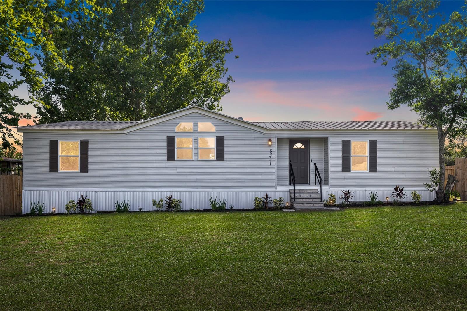 Welcome home to this beautifully remodeled 3-bedroom, 2-bath property situated on a spacious 0.27-acre lot with no HOA or CDD fees. This move-in-ready home features an open-concept floor plan designed for comfortable living and entertaining. Recent updates completed in 2026, per seller, include new flooring throughout, fresh interior and exterior paint, new drywall, doors, electrical switches and outlets, a new exterior skirt, and a tankless water heater. The updated kitchen boasts new appliances and modern finishes, while both bathrooms have been tastefully remodeled. Step outside to enjoy the newly installed wooden privacy fence surrounding the backyard, complete with a firepit—perfect for relaxing evenings or gathering with family and friends. A durable metal roof provides added peace of mind and long-term value. With extensive renovations, modern upgrades, and a large fenced yard, this home offers the perfect blend of style, comfort, and functionality. Conveniently located within 10 minutes of shopping, dining, schools, parks, medical facilities, and within an hour from Tampa. Schedule your private showing today!