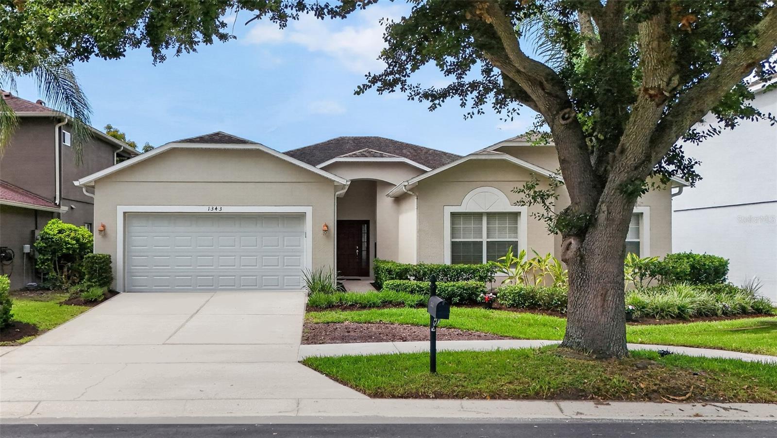 Welcome to this beautifully landscaped 3-bedroom, 2-bathroom home in the 24-hour guard-gated Stoneybrook West community. Featuring a split-bedroom floor plan, the layout includes a versatile flex room ideal for a home office or den. The kitchen is equipped with white appliances and granite countertops and flows easily into the main living spaces, with ceiling fans installed throughout the home for comfort. A standout feature of this property is the seamless outdoor integration: the living room, family room, and primary suite all open directly onto a spacious, screened-in porch. The primary suite serves as a quiet retreat, complete with an attached bath featuring a garden tub and a separate walk-in shower. Residents of Stoneybrook West enjoy robust community amenities, including a clubhouse, swimming pool, golf course, tennis courts, and a private community boat dock with direct access to Black Lake.