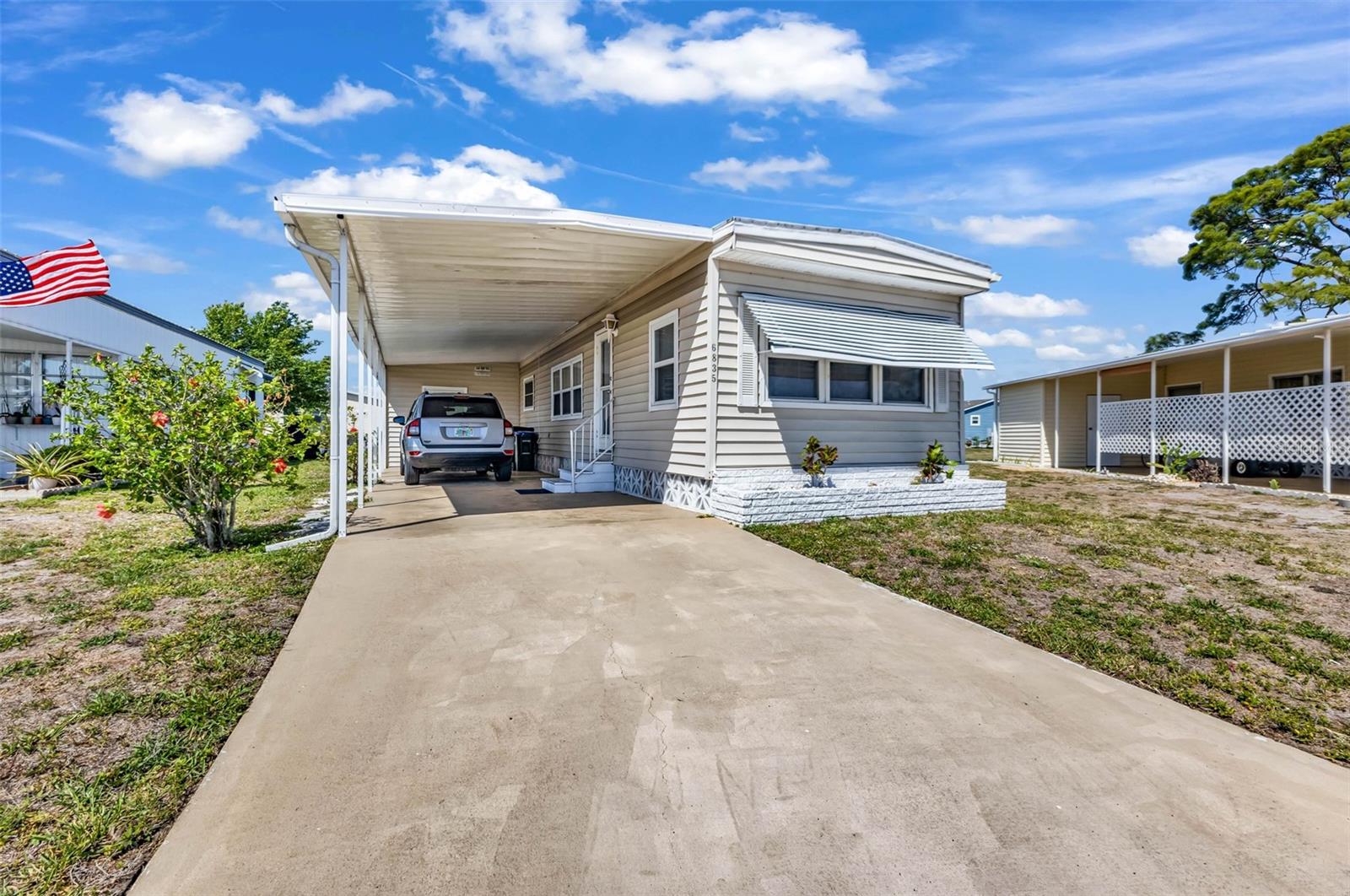 Welcome to 6835 Anapa Ct  located in the vibrant and highly sought-after 55+ community of Holiday Park! This beautifully updated 2-bedroom, 1-bath home offers comfort, style, and Florida living. Inside, you’ll find beautiful luxury vinyl plank flooring throughout and a bright open-concept layout connecting the living room, dining area, and kitchen — creating the perfect space for entertaining or relaxing. The updated kitchen features modern accents, stylish finishes, and brand-new appliances, blending functionality with contemporary design. Additional highlights include a updated membrane roof, storage/utility room, long driveway, covered carport, and well-maintained exterior. Whether you're looking for a seasonal getaway or full-time residence, this move-in ready home offers comfort and convenience in every detail. The low monthly maintenance fee of just $195 ($2,340 annually) is conveniently included in your property taxes. Residents enjoy an exceptional lifestyle with access to clubhouses, swimming pools, fitness center, library, tennis courts, pickleball courts, bocce courts, shuffleboard, horseshoes, ping pong, and multiple social gathering spaces. Holiday Park also offers a full calendar of activities and events within a beautifully landscaped, park-like setting designed for active living and vibrant social opportunities. Ideally located just minutes from shopping, dining, entertainment, golf courses, sports facilities, nature parks, and the stunning Gulf Coast beaches of Southwest Florida, this home truly has it all. Move right in and start enjoying the Florida lifestyle — schedule your private showing today!