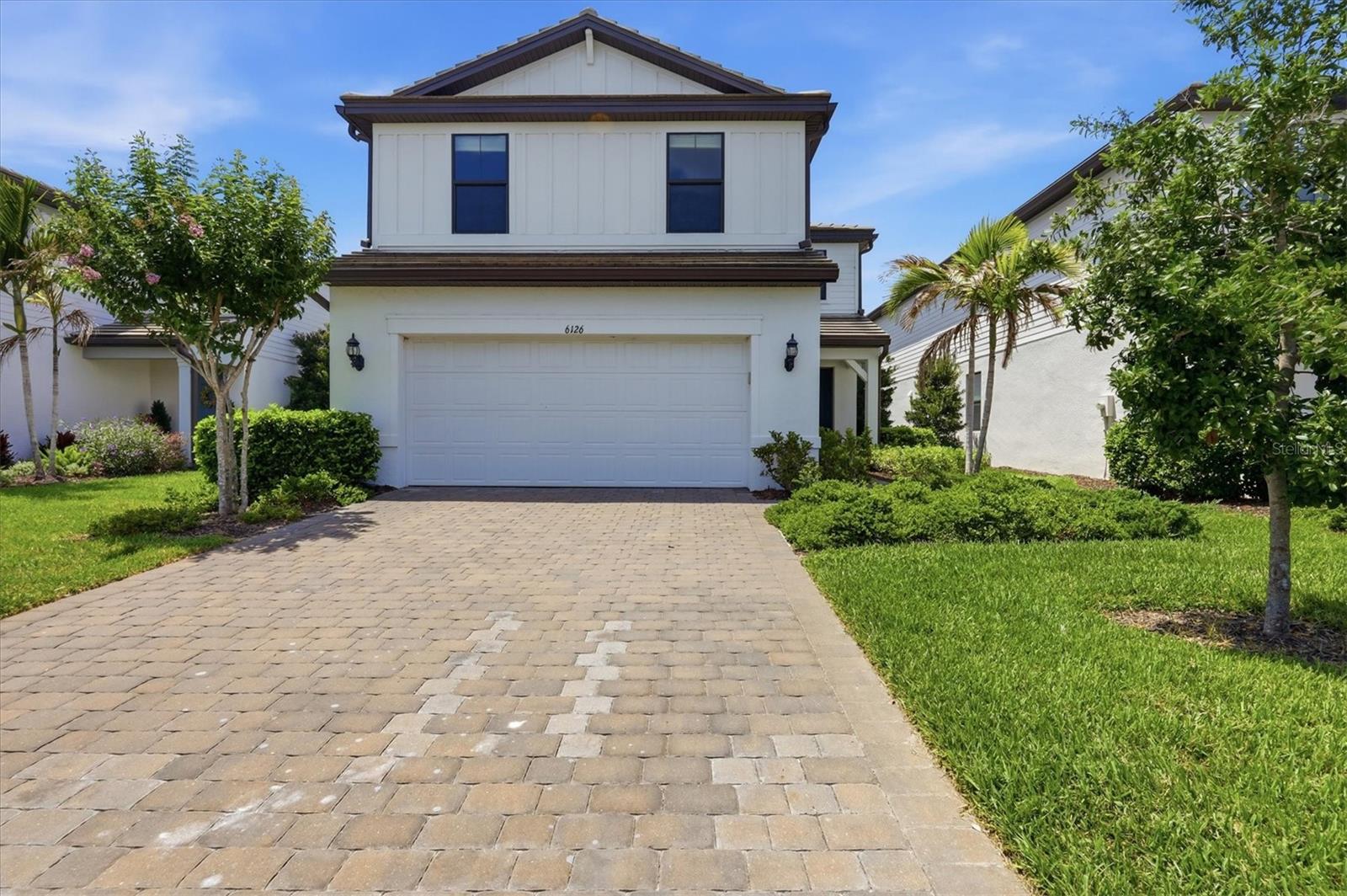 Short Sale. Welcome to 6126 Bluestar Ct, located in the desirable Sapphire Point community of Lakewood Ranch. Built in 2021, this beautifully maintained 5-bedroom, 3-bathroom home offers the sought-after Trailside floor plan with 2,710 square feet of thoughtfully designed living space. Move-in ready and filled with quality upgrades, this home features hurricane impact glass throughout, an extended garage, and a private backyard with tranquil water and preserve views. Step inside to an open-concept first floor designed for both comfortable everyday living and entertaining. The spacious kitchen overlooks the living and dining areas and is appointed with stainless steel appliances, quartz countertops, and ample cabinetry. A first-floor bedroom and full bathroom provide flexibility for guests, a home office, or multigenerational living. Sliding doors lead to the covered lanai where you can relax and enjoy peaceful water views with a preserve backdrop, creating a private outdoor retreat. Upstairs, a versatile loft/flex space offers endless possibilities as a playroom, media room, office, or additional living area. Two secondary bedrooms and a full bathroom are located just off the loft, along with a conveniently positioned upstairs laundry room. Down the hall, you’ll find an additional bedroom and the spacious primary suite featuring a private ensuite bathroom designed for comfort and relaxation. Located within the gated community of Sapphire Point, residents enjoy an exceptional lifestyle with resort-style amenities including a sparkling pool, clubhouse with catering kitchen, fitness center, playground, dog park, fire pit, and more. Surrounded by over 60 acres of preserved natural landscape and 35 acres of scenic lakes, the community also offers convenient access to top-rated schools, premier sports facilities, and the shopping, dining, and entertainment of Lakewood Ranch.