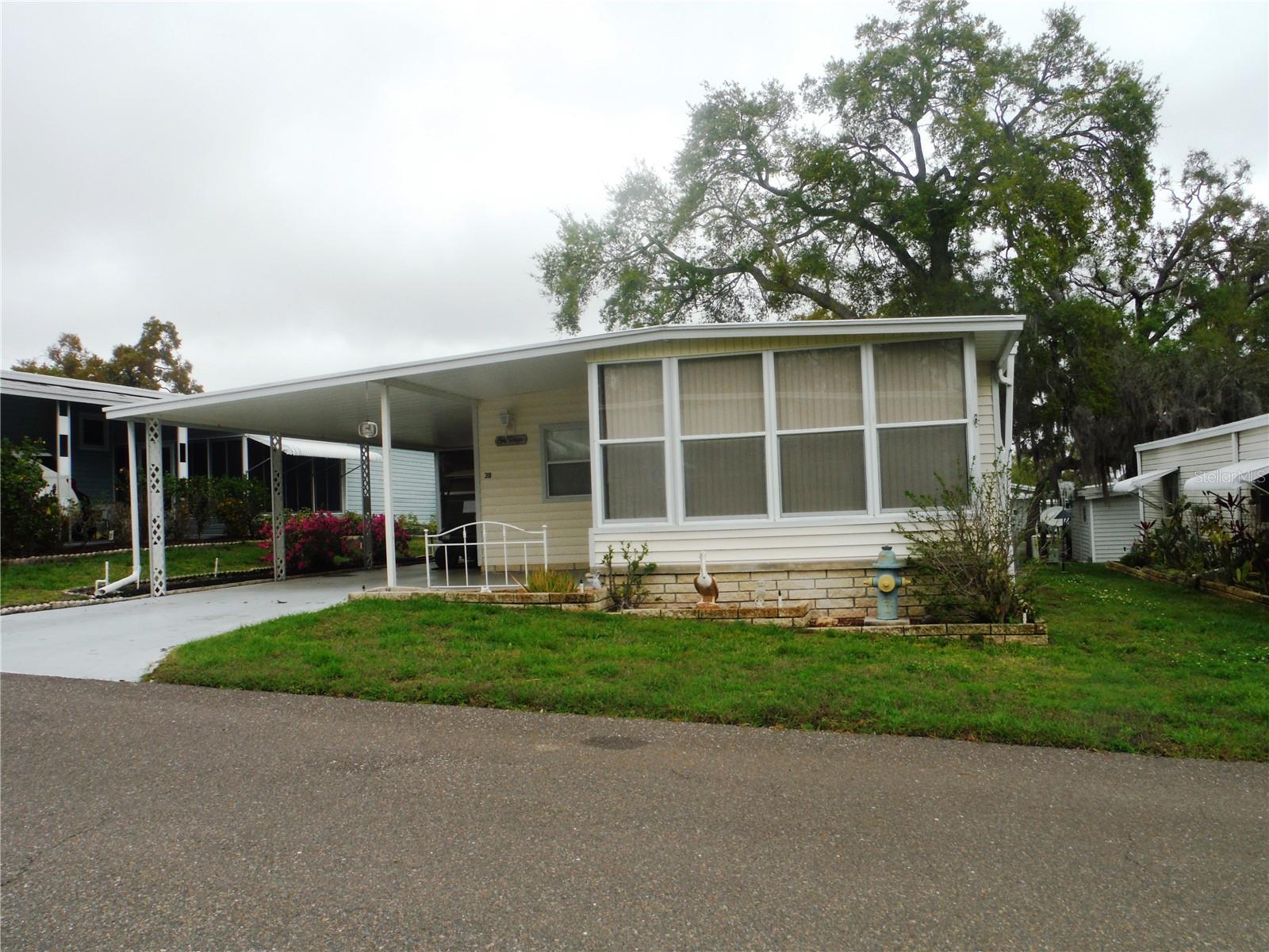 2 bedroom 2 bath. New HVAC & ductwork replaced for $11,300 in June 2026, vapor barrier and anchors done in 2014. Master bedroom shower & floor in 2008, roof checked and screws sealed in 2017. Fridge installed 2020, disposal 2025.  Great area in dog section allows a cat or a dog up to 25 pounds.  This home is in a no flood zone(X).  It is being sold furnished so you can move right in if you want a 2nd home as a snowbird or you can use as a principal residence.  Maintenance fee is only $235/Month since you actually own the deeded lot included in the price which is 50X80.  Maintenance fee includes water, sewer, trash, lawn, clubhouse, heated pool & spa, private roads, shuffleboard, laundry room in case your appliances break, and a really cool mart where you can donate items and the proceeds from the sales go toward the community activities. Room measurements approximate.
