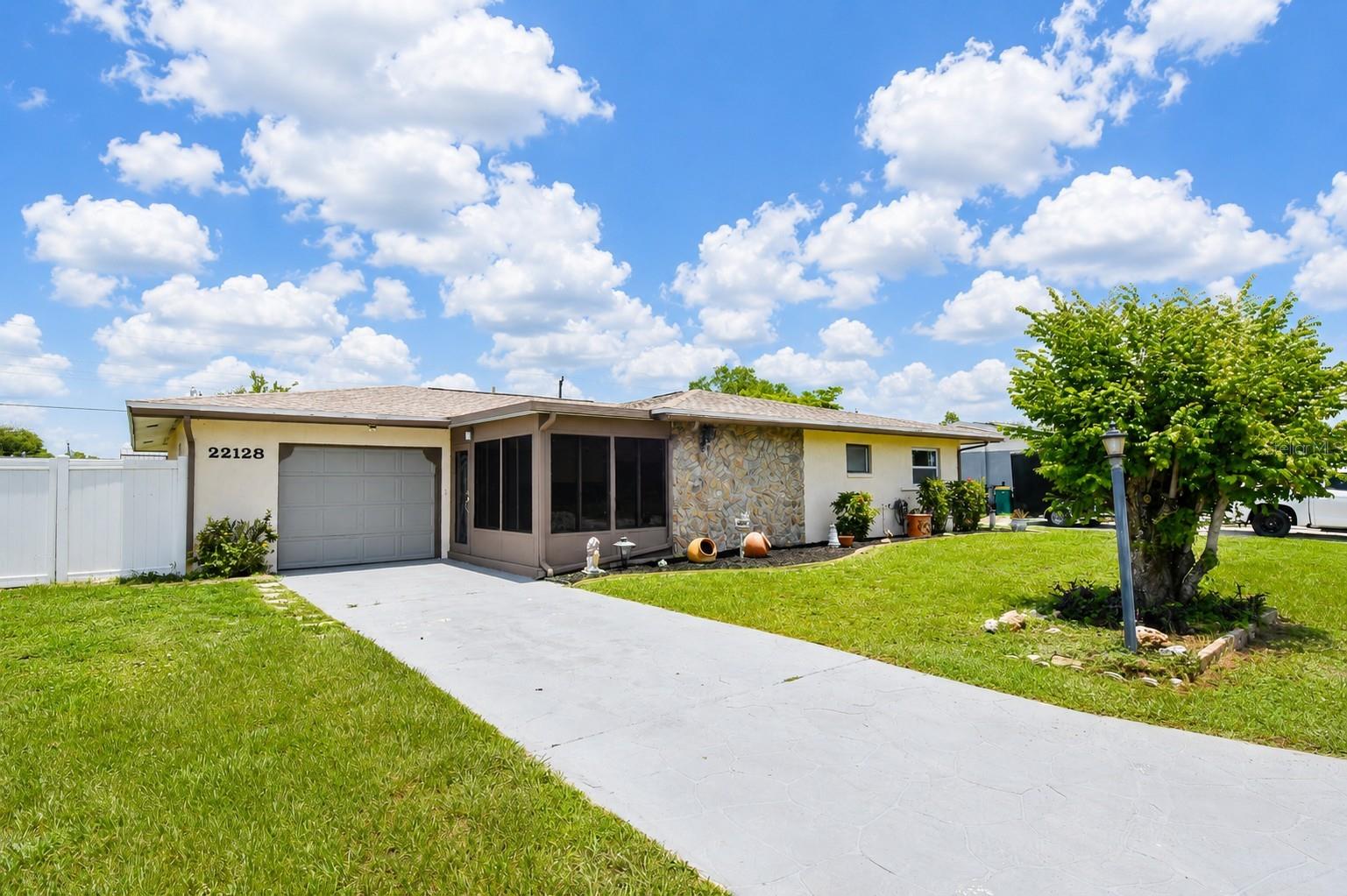 Welcome to 22128 Bronxville Ave in Port Charlotte, Florida.  Highly sought after New York area of Port Charlotte. It's where classic charm meets move-in-ready living. This well-maintained 3-bedroom, 2-bath home delivers the updates buyers care about without sacrificing character.  Major systems are already handled: new roof (2022), PEX repipe (2019).   The home has been fully refreshed with interior and exterior paint, plus a sealed driveway—so it shows clean and worry-free from day one. Inside, you’ll find a bright, open living space that feels larger than expected and works for both everyday living and entertaining. The layout flows naturally to the backyard, creating a seamless indoor-outdoor feel. Out back is where this property separates itself—mature fruit trees, a covered patio, and a private setting that actually invites you to use the space. Morning coffee, shaded afternoons, and low-key evenings. Storage isn’t an afterthought here. Between multiple storage areas and an attached garage, there’s room for tools, toys, and everything in between. This home is less than 3 minutes away from the Sunseeker Resort, 10 minutes to Punta Gorda airport, fine dining, Fisherman’s Village and shopping. It is also located less than 30 minutes to beautiful Gulf beaches, The Braves Stadium, Historic Downtown Venice and Punta Gorda. Live in quiet tranquility while loving the layout of this lovely home Whether you're buying your primary home, a seasonal escape, or a rental home- Visit this one today.
