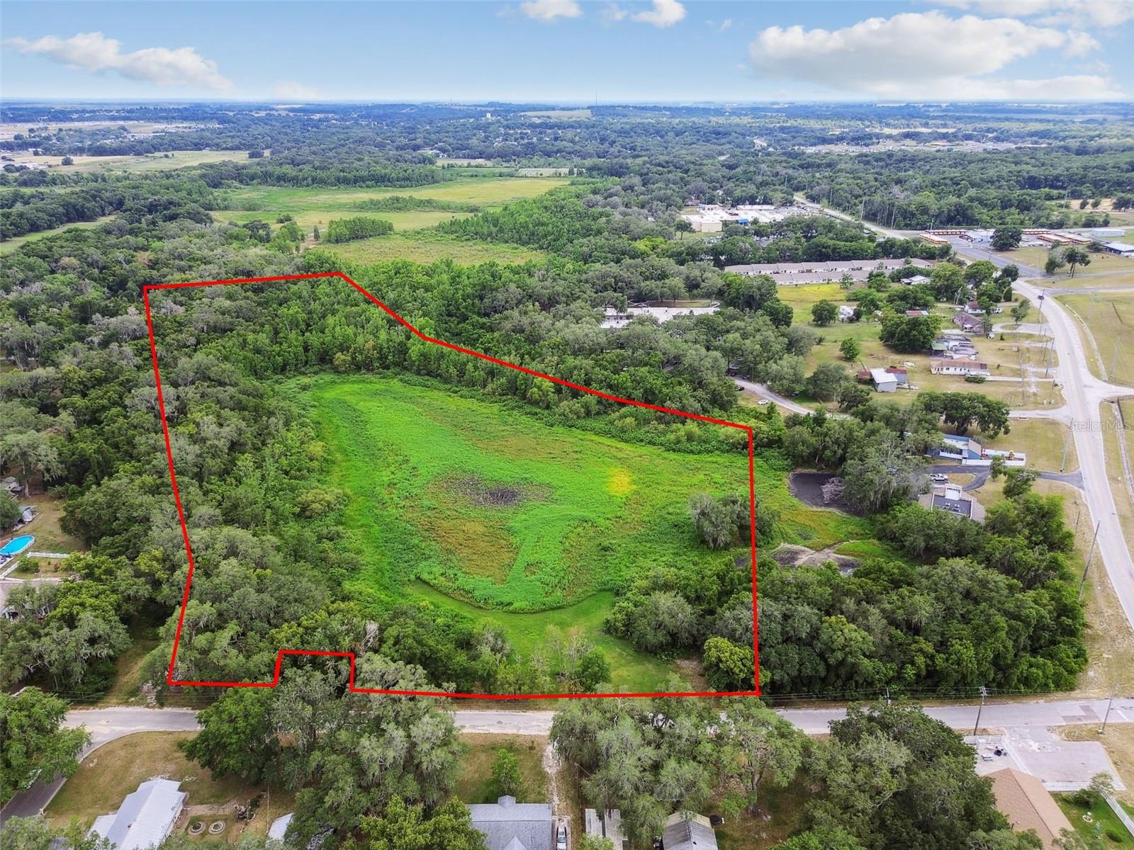 Nestled in the heart of Pasco, this expansive property offers a rare chance to create your dream retreat. Imagine a winding driveway encircling a picturesque lake, leading to your private estate. With over 2 acres of uplands at the rear, there’s ample space to build a stunning home surrounded by lush trees and local wildlife, ensuring both privacy and tranquility. For added seclusion, a gated entrance can be installed, giving you full control over your personal sanctuary. This one-of-a-kind property is truly unmatched in the market. Conveniently located near Pasco High School (home of the Pasco Pirates) and an elementary school, it provides a peaceful, country-like atmosphere while remaining close to essential amenities. Don't miss out on this extraordinary opportunity—schedule a visit today!