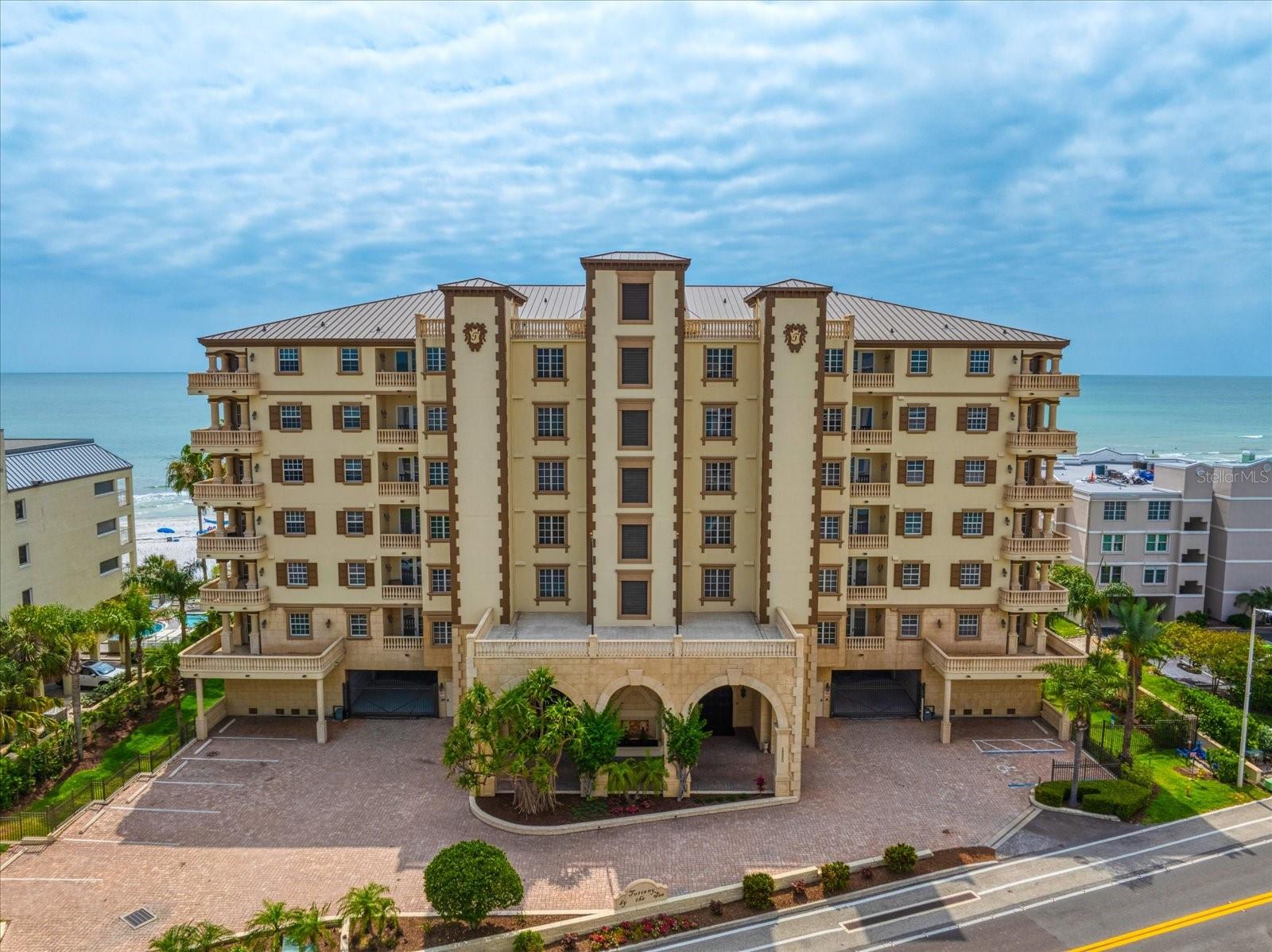 Discover unparalleled luxury at this expansive 5,400 square foot penthouse condo nestled within the prestigious Tuscany By The Sea in Indian Shores. Offering panoramic views of the Gulf of Mexico and the Intracoastal Waterway, this residence epitomizes coastal elegance.

Step into the grand foyer via the private elevator and marvel at the designer marble flooring, tray ceilings, and crown molding that adorn the living spaces.

Entertain guests in the spacious living and dining areas featuring two fireplaces, a breakfast nook, and well-appointed bar.  Watch the glorious sunsets and wildlife from the 80ft terrace also perfect for entertaining. The primary suite is a retreat unto itself, with dual vanities, a lavish walk-in shower, a jacuzzi soaking tub, and dual custom built walk-in closets.

Amenities include and oversized laundry room, utility/storage closet, and a private 2-car garage.  Outside, the Gulf-front pool area, two heated spas, and direct private beach access.  Seize this rare opportunity to own a piece of paradise along the Gulf Coast. 
One or more photos have been virtually staged.