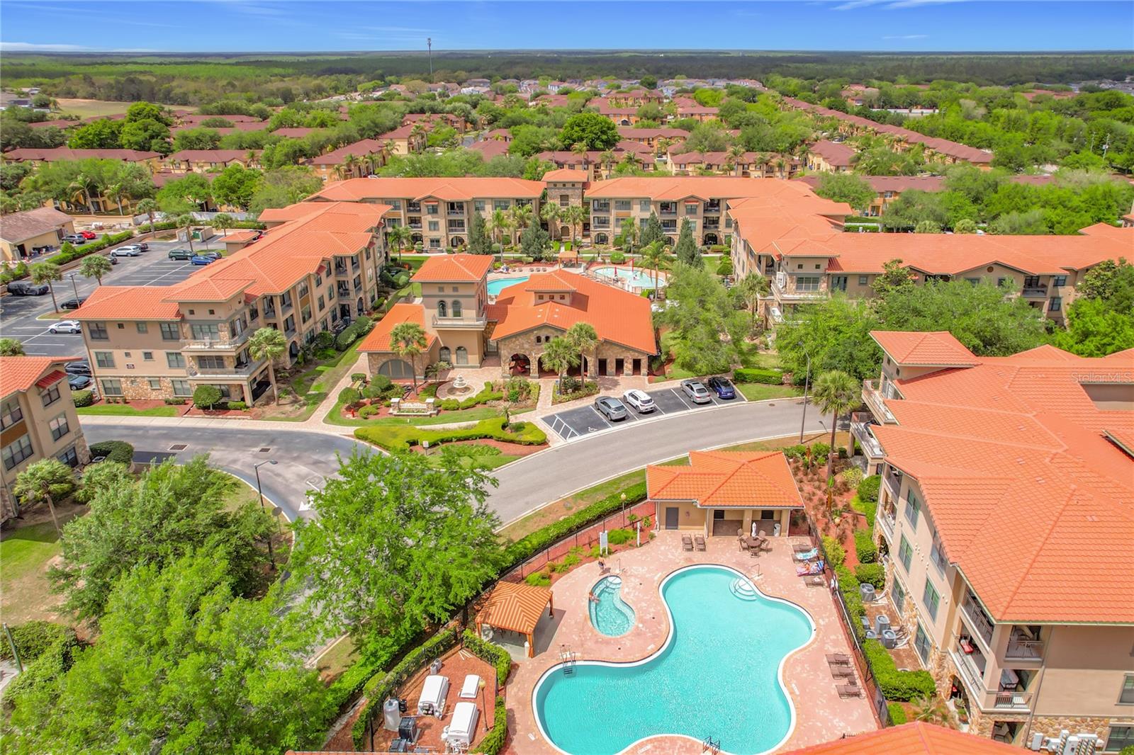 Welcome to your Tuscan-style resort residence at Bella Piazza in Davenport, a charming Mediterranean-inspired community just minutes from Disney and Orlando’s top attractions. This inviting ground-floor Turn Key condo offers a bright and spacious living area perfect for gatherings, featuring tile flooring and crown molding throughout the main living room. The kitchen boasts cherry wood-grain cabinets, a porcelain tile backsplash, stone countertops, and a raised breakfast bar that opens to the dining and living areas. The great room includes built-in shelving, a ceiling fan, and plenty of space for entertaining.
Unwind in the serene owner’s suite with luxurious en-suite bathroom complete with stone countertops, dual sinks, a garden tub, and a separate shower. The second bedroom has convenient access to a full bath with stone countertops and a tub/shower combo. A full-size stackable washer and dryer add everyday convenience.
Step outside to your covered rear porch, the perfect spot to relax after a fun-filled day at the parks. Bella Piazza offers exceptional resort-style amenities including two sparkling community pools, a kid’s splash area, a well-equipped fitness center, a game room, business center, and community BBQ grills— all surrounded by lush tropical landscaping.
The condo fee includes water, sewer, trash, internet, cable, and exterior maintenance for worry-free living. Zoned for both residential and short-term rental use, this property is ideal as a primary residence, personal vacation home, or investment opportunity. With Publix and restaurants just a short walk away, and easy access to shopping, dining, major highways, and Orlando International Airport, convenience is truly at your doorstep.  (ROOF less then 2 years old, AC 4 years old, Water Heater 5 years old)