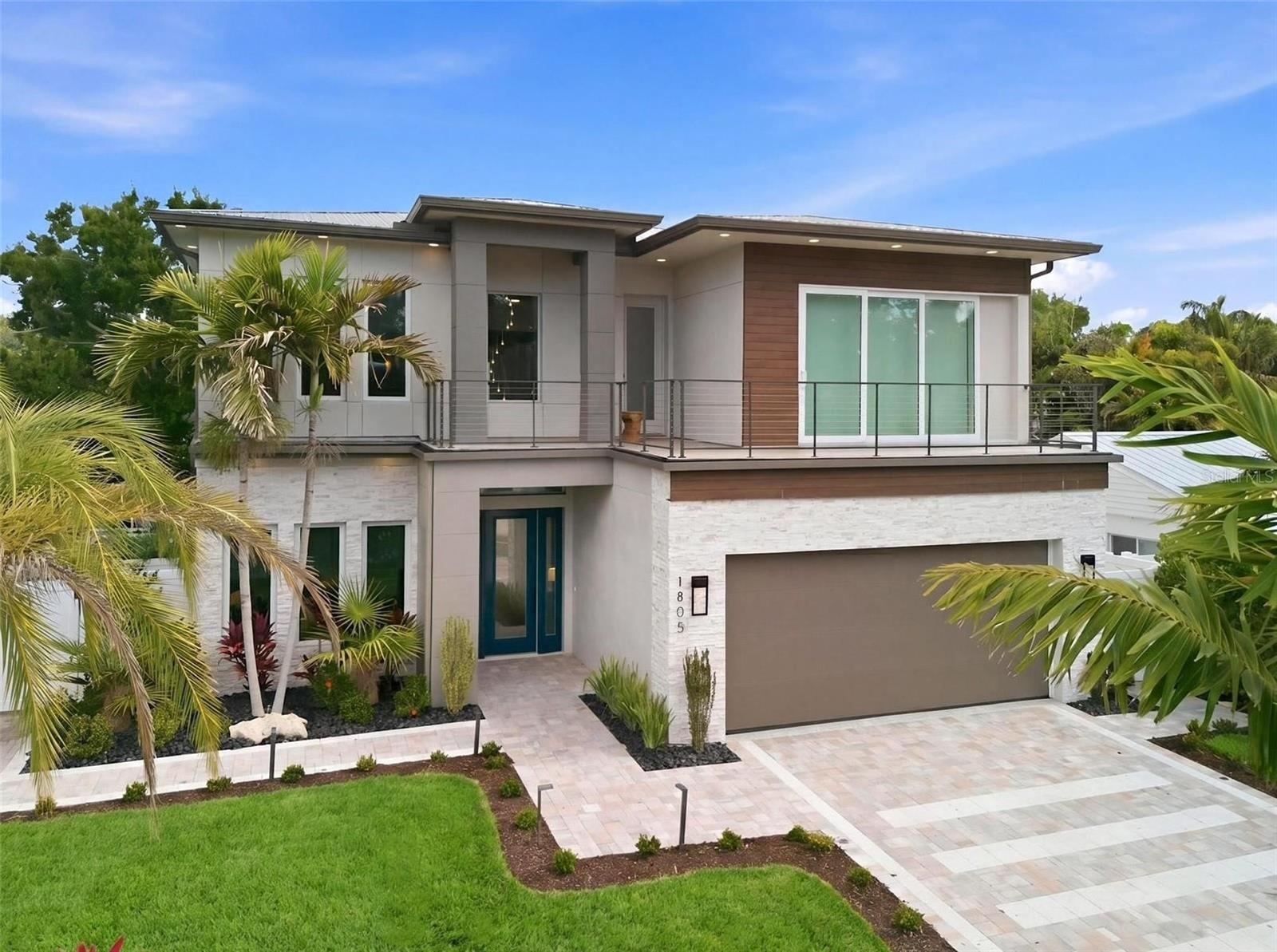 Welcome to this exceptional new construction, upgraded residence located West of Trail, featuring 5 bedrooms, 5 full bathrooms, and 3,640 square feet of thoughtfully curated living space. Designed with a refined modern aesthetic, the home blends clean architectural lines with elevated finishes and seamless indoor-outdoor living. Upon entry, soaring 20-foot ceilings, warm designer lighting, and an expansive open-concept floor plan create an immediate sense of scale and refinement. The chef’s kitchen is appointed with premium GE Café appliances, quartz countertops, and custom cabinetry, flowing effortlessly into the main living and entertaining spaces. The residence also includes a spacious two-car garage equipped with an installed electric vehicle charger for added convenience and modern functionality.

Walls of sliding glass doors open to a beautifully enhanced outdoor retreat featuring lush upgraded landscaping, a resort-style pool with a newly added waterfall feature, a fully equipped outdoor kitchen, and a covered dining area complete with remote-controlled mosquito and sun screens for year-round comfort and effortless entertaining. The primary suite serves as a private sanctuary, filled with natural light and designed for both comfort and elegance. The space features a generous walk-in closet, direct access to the outdoor living area, and a spa-inspired bath with a soaking tub and separate glass-enclosed shower. A newly installed stainless steel Bosch built-in coffee system adds an additional layer of luxury, while designer wallpaper and remote-controlled screens throughout the home provide a refined finish and enhanced comfort.

Upstairs, three spacious guest suites each feature their own en-suite bathroom, creating ideal accommodations for family and visitors alike, in addition to a spacious media room designed for relaxed living and entertaining. A large rooftop terrace overlooking the pool provides an exceptional setting for relaxing or entertaining. Perfectly positioned between Siesta Key and Downtown Sarasota, this residence offers convenient access to world-class beaches, dining, shopping, and cultural attractions. Thoughtfully designed with timeless architecture, elevated finishes, and exceptional attention to detail throughout, this home delivers an elevated yet comfortable living experience for modern luxury living.