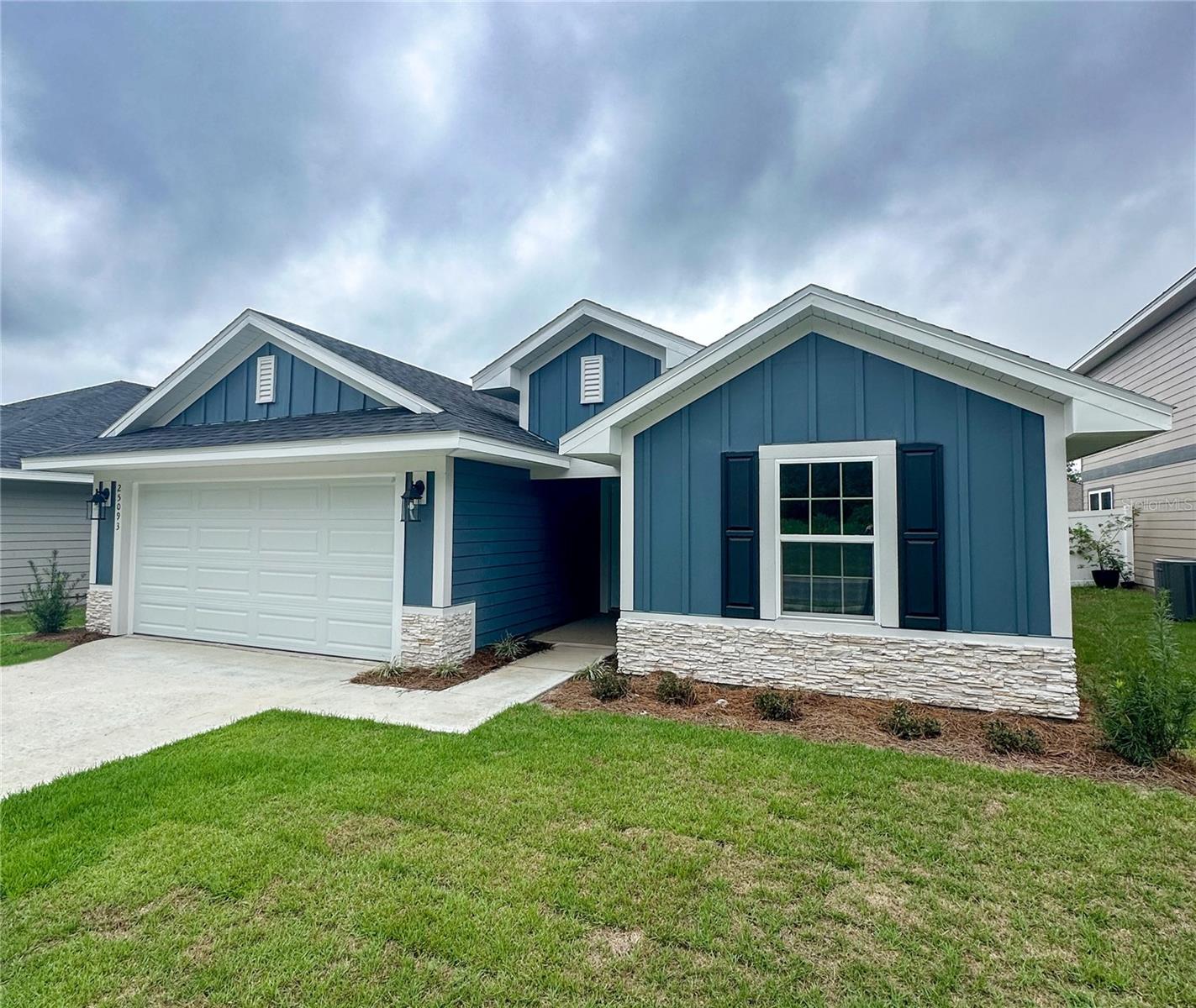 Virtually Staged. Under Construction. Family-friendly new construction located only fifteen minutes from Gainesville in a growing Alachua community, just five minutes from I-75. This home offers the space and features desired while keeping Gainesville’s schools, healthcare, outdoor recreation, and employment opportunities within a short drive. Modern comfort, everyday convenience, and access to North Florida’s education, amenities, and lifestyle opportunities come together in one well-positioned location.
Now offering builder incentive that can cover closing costs with preferred lenders with $30k flex cash for closing costs, rate buy-down, or upgrades. Or 4.99% fixed interest rate plus $10k flex cash through Acrisure mortgage.

***Interior***
This approximately 1,635 sq. ft. residence features a 4-bedroom, 2-bath layout designed for functionality and comfort. The kitchen is equipped with a large island. Both the Kitchen and  bathrooms include upgraded solid wood cabinets with soft-close drawers, finished with matte black decorative hardware plus granite countertops.
The home includes luxury vinyl plank flooring. The primary bathroom features a ceramic tile 5-foot walk-in shower as an upgrade option and his-and-hers sinks come standard. Brand-new stainless steel appliances, including a dishwasher, microwave, and range/oven, along with a garbage disposal. Window blind inserts are installed in all rear exterior doors for added privacy and convenience.

***Exterior***
Additional highlights include LED lighting throughout, double-pane insulated windows, and a TAEXX built-in wall pest control system. The exterior showcases fiber cement (Hardie-style) siding with stacked stone accents. Includes a 2-car garage plus additional driveway space for two vehicles.

***Location***
Ideally situated in Alachua five minutes from I-75 and next to Santa Fe High School. Everyday essentials like Publix, Ellianos coffee and brand new Wawa and Chick-Fil-A are within 5 minutes.

***Amenities***
Outdoor recreation is easily accessible, with Legacy Park approximately. 9 minutes away, offering basketball, volleyball, baseball, football and soccer, performance stage, playground, splash pad, and an 18-hole disc golf course. San Felasco Hammock Preserve State Park is approximately 11 minutes away providing mountain biking, hiking, and equestrian trails. A short drive places you in Gainesville, home to the University of Florida, UF Health, higher education opportunities, dining, nightlife, and cultural attractions. The area also provides access to North Florida’s natural springs and outdoor recreation, including swimming, kayaking and Florida Parks

***Builder and options***
The home is built by Adams Homes, a family-owned builder locally operated and known for value-focused construction. Pre-sales are currently available with only a $1,000 deposit and an agreement to purchase. Act now to personalize exterior colors, roof color, countertop material, stacked stone accent and flooring colors.
Now offering builder incentive that can cover closing costs with preferred lenders with $30k flex cash for closing costs, rate buy-down, or upgrades. Or 4.99% fixed interest rate plus $10k flex cash through Acrisure mortgage.

Schedule your private showing or inquire today to learn more about available homesites and current presale opportunities. Images are not of actual home as construction is yet to begin.