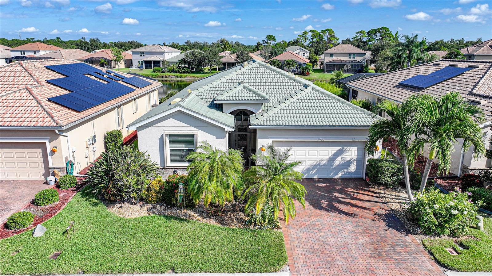 Welcome to this stunning 4-bedroom, 3-bathroom home with a 2-car garage, perfectly positioned on a serene lake in the desirable gated community of Stoneybrook at Venice. Offering over 2,000 square feet under air, this home combines spacious living with elegant finishes and resort-style amenities.
Step inside to find 10-foot ceilings with crown molding that create an open, airy feel throughout the main living areas. The diamond pattern tile flooring in the main spaces provides a clean, modern look, while carpeted bedrooms offer comfort and warmth. The kitchen is a true centerpiece, featuring granite countertops, a stylish tile backsplash, pendant lighting over the island, and a large pantry—perfect for both entertaining and everyday living.
Enjoy beautiful lake views from the living room through the 8-foot sliding glass doors that opens to a screened-in lanai, ideal for relaxing mornings or peaceful evenings outdoors. An added electrical outlet on the lanai for an outdoor kitchen while another outlet at the BBQ Grill area for the rotisserie. An additional outlet at the front of the home is perfect for holiday decorating. Low voltage wiring has been installed for accent lighting in the front yard. A screened in front entry allows you to open your front door without flying insects entering.
The spacious primary suite offers a private retreat with a luxurious ensuite bathroom featuring a garden tub, walk-in shower, and dual vanities.
Additional upgrades include attic stairs and plywood flooring for easy attic storage, and a generator wired directly into the electrical panel—simply flip a switch to power your home during an outage.
Residents of Stoneybrook enjoy a vibrant, active lifestyle with access to a state-of-the-art fitness center, resort-style pool, tennis and pickleball courts, basketball, volleyball, and playgrounds—plus a full calendar of community events and social gatherings.
Located just minutes from Downtown Venice, Downtown Wellen Park, and the Gulf beaches, this home offers the perfect blend of comfort, convenience, and Florida lifestyle.