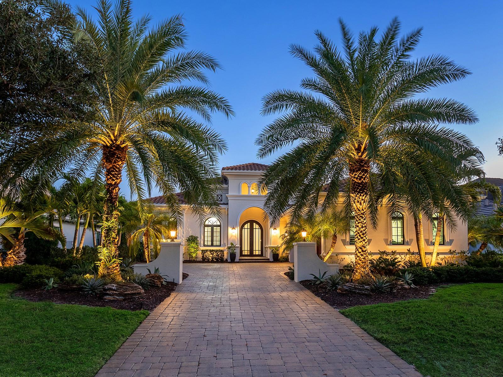Welcome to 16218 Daysailor Trail, an exceptional estate residence set behind the gates of The Lake Club at Lakewood Ranch. Built in 2018 and meticulously maintained, this nearly 3,100-square-foot, single-level home embodies refined Florida living, offering expansive unobstructed long lake views and desired southern exposure that provides a tranquil, ever-changing natural backdrop. Positioned on a premier waterfront homesite, the property features over $57,000 in recent upgrades and a thoughtfully curated selection of upscale finishes throughout. Enter through the double glass and iron doors into a bright, timeless interior where the expansive great room impresses with high-volume ceilings accented by wood beams, rich hardwood flooring, a gas fireplace, and pocketing impact-glass sliders that seamlessly blend indoor and outdoor living. The outdoor living space is equally compelling, offering generous covered lounge and dining areas, a fully equipped outdoor kitchen, and a heated saltwater pool and spa, all overlooking private lake views designed for year-round enjoyment. At the heart of the home, the chef’s kitchen is a showpiece, offering double-stacked wood cabinetry with glass-front uppers, lighted interiors and slide-out shelving. Premium appliances include a Wolf gas cooktop, wall oven and microwave, Sub-Zero built-in refrigerator, Miele dishwasher and a walk-in pantry with custom shelving. Calacatta Lazza quartz countertops, a stacked herringbone backsplash, farmhouse sink and elegant pendant lighting complete the island, which doubles as a breakfast bar and flows seamlessly into the dining area. The dining room, with corner sliding glass doors and serene water views, is an entertainer’s dream. The private primary suite offers a peaceful retreat with French doors flowing to the lanai, two spacious walk-in closets with custom built-ins, and a spa-inspired bath featuring split vanities, a large walk-in shower and a soaking tub. Two additional en-suite bedrooms provide comfort and privacy for family and guests. A versatile bonus room, used as a fourth en-suite bedroom with hardwood flooring, adds flexibility to the floor plan. The den, ideal for a home office, features wood flooring, plantation shutters and pocketing glass French doors, creating a quiet space for work or relaxation. Additional highlights include professionally designed landscaping with accent lighting, Italian plumbing fixtures, plantation shutters throughout and custom window treatments, central vacuum with kitchen kick sweep, solid-core interior doors, crown molding, 7¼-inch baseboards, whole-house surge protection, a newer pool heater, recently painted exterior, Honeywell Wi-Fi thermostats, replacement of all pool screen frame bolts and a three-car garage with EV charging station. A discreet side-yard dog run with turf completes the thoughtful design. Meticulously cared for and move-in ready, this exceptional home delivers a balance of elegance, comfort and effortless luxury. The Lake Club is a gated community anchored by an impressive 20,000-square-foot clubhouse offering a collection of luxury amenities. Residents enjoy two resort-style pools, including a zero-entry pool with a splash park, poolside dining, a full-service spa and a state-of-the-art fitness center, tennis and pickleball courts with professional racquet staff cater to sports enthusiasts, and an active social calendar keeps the community connected year-round. Total tax amount includes CDD fee.