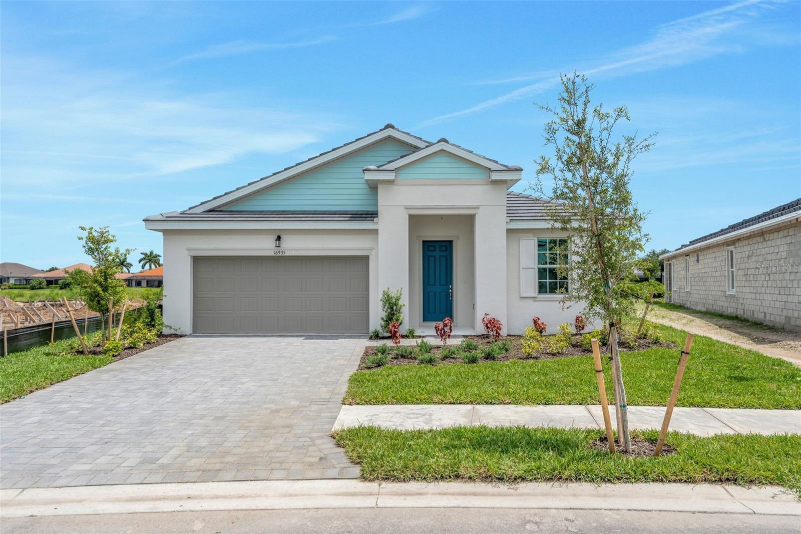 Virtually Staged. Experience modern Florida living in the Lucca Model at River Hall Country Club. Located on an 8,873-square-foot homesite, this 1,971-square-foot residence offers 3 bedrooms and 3 full bathrooms with a bright open layout. The main living area connects the gathering room, dining space, and kitchen with a large island and walk-in pantry. The private owner’s suite includes a walk-in closet, dual vanities, and a spacious walk-in shower. Secondary bedrooms provide flexible use options. A tandem garage adds extra storage and functionality, well-suited for a golf community lifestyle. River Hall Country Club features a championship golf course, clubhouse, fitness center, resort-style pool, tennis, pickleball, bocce, cabanas, and walking trails.
