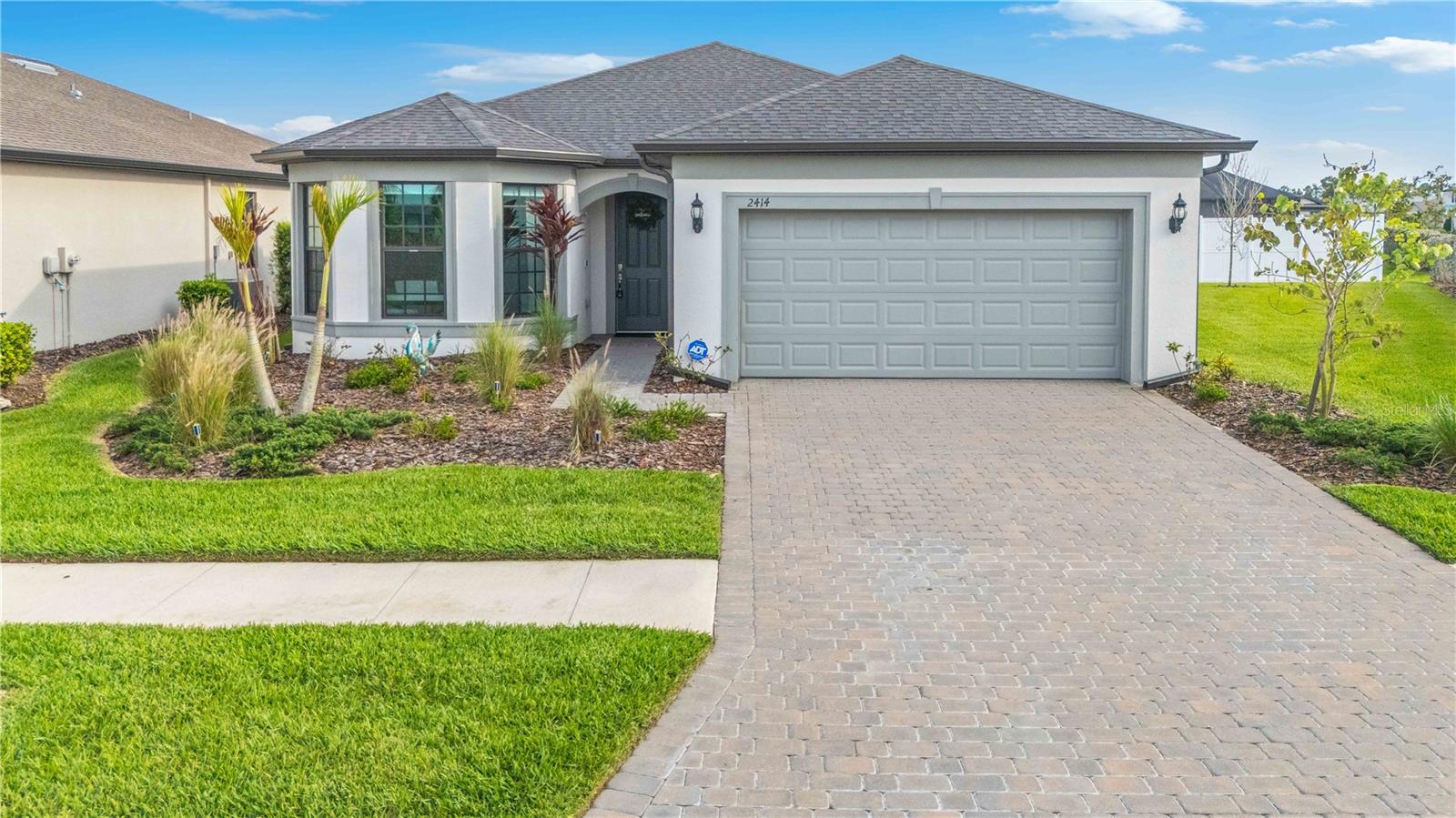 Welcome to your piece of paradise in the highly sought after community of Cedar Grove. Don’t be fooled by lower tier builds, this one stands apart from others and is sure to impress! This BETTER THAN NEW home has countless upgrades not included in other homes! IMPACT WINDOWS AND SLIDERS keeping your home safe year round and no flood insurance required! Upon Arriving to the home you will notice the attractive curb appeal and privacy provided by the vinyl fence in the backyard along with being situated on a corner lot. Once inside you will be greeted by an open layout with tall ceilings, 8 ft doors, and tile floors throughout the entire home. The kitchen features quartz countertops, solid wood cabinets with soft close doors, stainless steel appliances and the upscale appearance of a cook top and built in wall oven. All bedrooms are large with built in California closets and there is an enclosed office that could be converted to a 4th bedroom if desired. The interior laundry room, oversized pantry, and closets throughout the home will provide ample storage and the home has smart home featurs, whole home water filtration system, and water softener. The screened in lanai has pavers matching the driveway and offers a great spot to entertain guests. This community offers a resort style HEATED pool area, playground, and basketball courts allowing you to truly enjoy where you live while also having yard maintained and irrigation included. Ask your agent for the fully interactive 3D tour and prepare to fall in love.