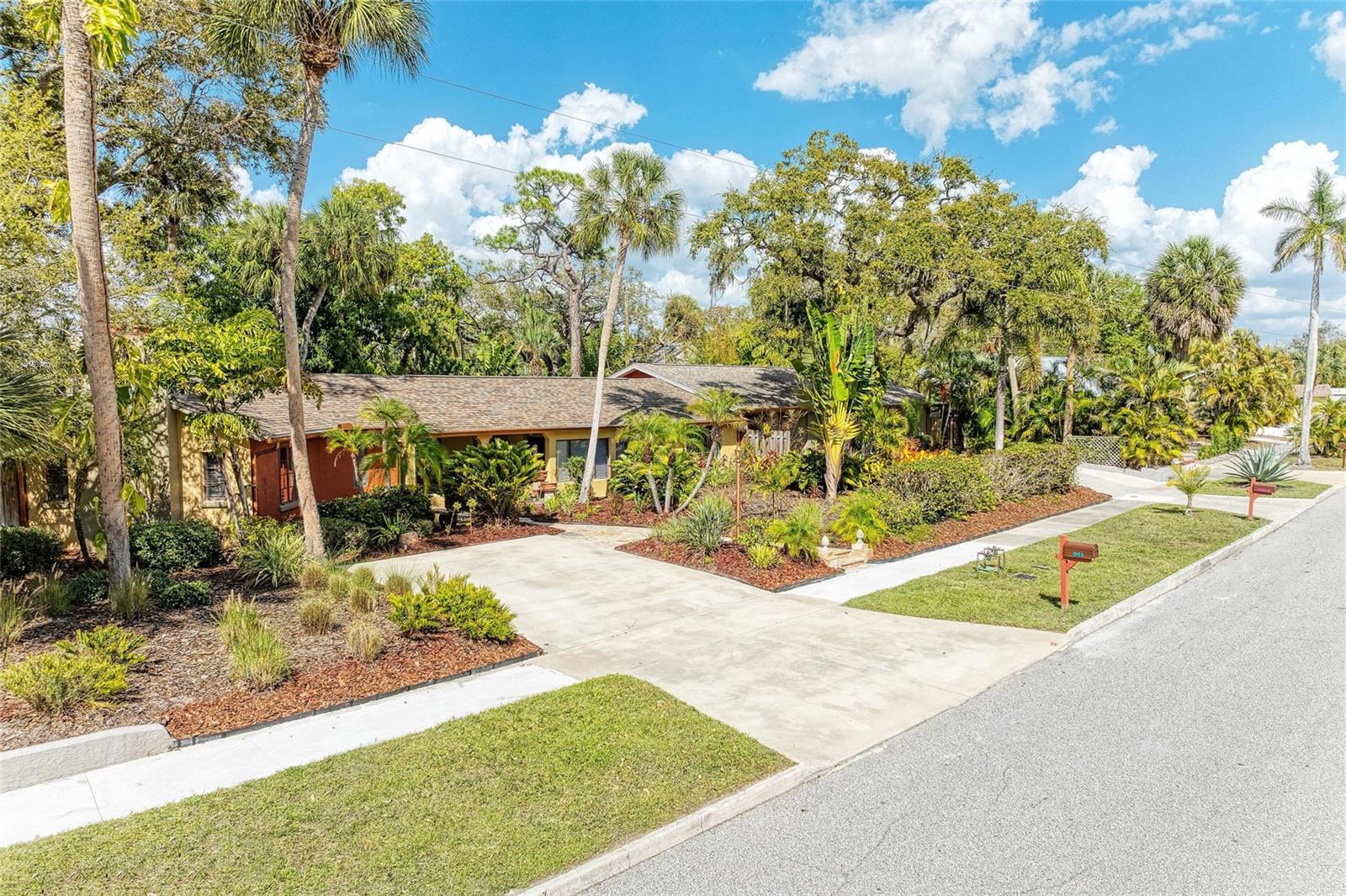 A Rare Piece of Sarasota History. Four turn-key furnished residences. Three City Lots. One Extraordinary Piece of Sarasota History. Welcome to 941 Virginia Drive, a truly unique historic property originally built by John Ringling Jr., offering vintage Sarasota charm paired with modern flexibility and lucrative income. Set on three city lots, this 125-foot-long masonry residence creates an extraordinary private compound with four distinct living spaces. The main residence features two bedrooms, one and a half bathrooms, and an office or den, highlighted by timeless architectural details including stone porches, arched doorways, pecky cypress paneling, tall vaulted beamed ceilings and a wood-burning fireplace. Modern updates complement the historic character with stainless steel appliances, granite countertops, and updated fixtures. The property is designed for lifestyle, opportunity and flexibility for extended family, guests or continued successful short-term rental business. In addition to the main home, the estate includes three separate guest residences providing privacy and versatility. There are two in-law suites that feature full kitchens, a private pool, hot tub, outdoor shower, patio access and a private bathroom; one offers one bedroom and the other two bedrooms. There is an additional one-bedroom dwelling with a convenient kitchenette, private bathroom and laundry. Located just two miles north of downtown Sarasota, the property offers easy access to Lido Key, Longboat Key, St. Armands Circle, and the vibrant dining, arts, and cultural scene of downtown Sarasota. Whether you envision a private historic estate, a multi-generational compound or a unique established vacation rental business, this rare property offers exceptional character, privacy and opportunity in one of Sarasota’s most desirable locations. Don’t miss this opportunity to Own a Piece of Ringling History — A Private Sarasota Compound with Vintage Charm and Resort-Style Living.