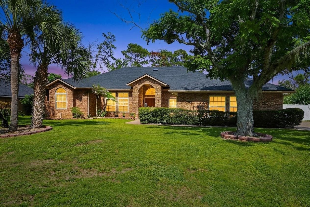 Florida living starts here in this spacious 3-bedroom, 2.5-bath pool home featuring a brick exterior, brand-new roof, more than 2,400 square feet of living space, and a half-acre homesite. Mature oak and palm trees, an expansive front yard, and a winding walkway leading to the double-door entry create inviting curb appeal.

Inside, the thoughtfully designed split-bedroom floor plan offers added privacy along with multiple living and dining areas for everyday comfort and entertaining. The family room opens to the kitchen and features tile flooring, a wood-burning fireplace, and French doors overlooking the outdoor living areas.

The updated eat-in kitchen includes granite countertops, stainless steel appliances, white cabinetry, and a large center island with bar seating. A light-filled dinette surrounded by windows overlooks the covered screened lanai and pool area, while separate formal living and dining spaces provide even more room to gather.

The spacious primary suite features two walk-in closets and an en-suite bathroom with a whirlpool soaking tub and separate walk-in shower. An adjoining bonus room offers flexible space for a home office, fitness room, nursery, media room, or private retreat and provides direct access to the covered screened lanai.

Located on the opposite side of the home, the secondary bedrooms share a full bathroom with direct lanai access - especially convenient for guests enjoying the pool. The connected floor plan also provides practical access from the garage through the laundry and bathroom areas.

Designed for indoor-outdoor living, the covered screened lanai offers a comfortable place to dine, relax, or enjoy morning coffee before stepping into the larger screened enclosure with pool and spa. Beyond the enclosure, the half-acre lot provides additional backyard space for recreation, gardening, or pets.

Additional features include a water heater replaced in 2023, a whole-home water treatment system with water softening and filtration, a Kenmore Elite central vacuum system, built-in speakers, a storage shed with electricity, and a two-car garage with a retractable screen.

Located in Crystal Lake Estates near shopping, dining, and convenient access to I-4, this home combines generous living space, a functional split-bedroom layout, and the Florida outdoor lifestyle. Schedule your private showing today!
