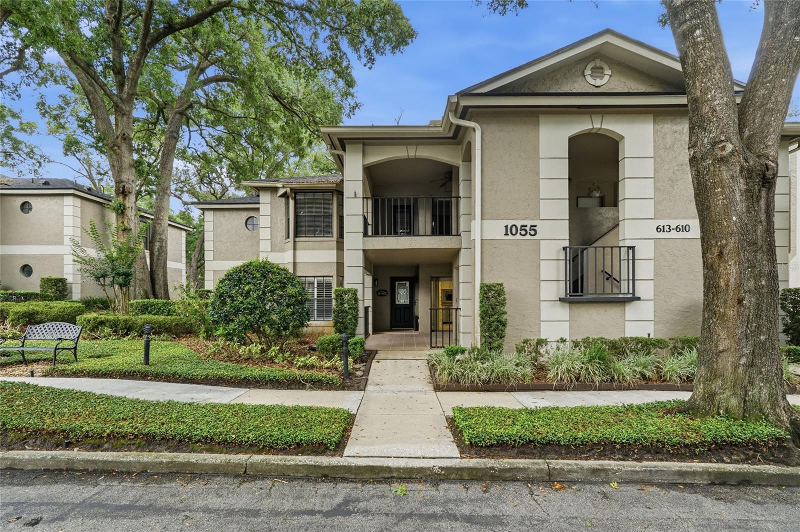 PRICED BELOW MARKET VALUE & MOVE-IN READY!

Don't miss this exceptional opportunity to own the largest 3-bedroom, 2-bath floor plan in the sought-after, gated community of Kensington Park. Offering 1,908 square feet of living space, this spacious ground-floor condominium has been freshly painted and is ready for its new owner.

Designed for comfortable, low-maintenance living, this first-floor residence offers inviting indoor and outdoor spaces. Enjoy your morning coffee on the covered front patio or unwind in the oversized glass-enclosed rear lanai overlooking the community tennis courts.
The well-appointed eat-in kitchen features abundant cabinetry, a pantry, stainless steel appliances, space for a dinette, and a sliding glass door that fills the room with natural light while providing access to the front patio. The adjacent dining area easily accommodates a large table, while the spacious living room is anchored by a charming brick fireplace, creating a warm and welcoming gathering space.
The oversized primary suite serves as a private retreat with two generous walk-in closets offering exceptional storage. The ensuite bathroom includes a double vanity, soaking tub, and separate walk-in shower. Two additional bedrooms provide flexibility for guests, a home office, or hobbies.

Additional features include ceiling fans throughout, Bahama shutters, and an assigned covered parking space.
The monthly HOA fee offers outstanding value by including cable, high-speed internet, water, trash, exterior building maintenance, and beautifully maintained grounds, providing truly carefree ownership.
Residents of Kensington Park enjoy an impressive selection of resort-style amenities, including two swimming pools, a hot tub, sauna, clubhouse, fitness center, indoor racquetball court, tennis courts, and pickleball courts. Surrounded by majestic live oak trees, this private gated community also features a convenient rear access gate and is ideally located near shopping, dining, medical facilities, and major roadways, making everyday living both convenient and enjoyable.

This move-in ready home combines generous living space, exceptional amenities, and an unbeatable value in one of the area's most desirable gated communities.