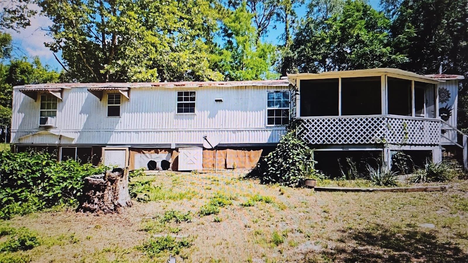 Welcome to 10541 SE 127th Ln Belleview Fl. Located minutes away from the Villages, Big Lake Weir and Carney Island State park. NO Lot rent or HOA. Inside, you'll find a spacious and functional layout featuring an open living, dining, and kitchen area with vinyl and title flooring throughout. To the right side the master bedroom features a bonus room that brings you to the backyard of the house. Step outside to your private oasis, featuring a refreshing pool with a recently installed deck, great for entertaining or enjoying peaceful Florida evenings. This cozy home is perfect for investors, first-time buyers, or those looking for a flip-and-fix opportunity. Scheduled your private showing today!