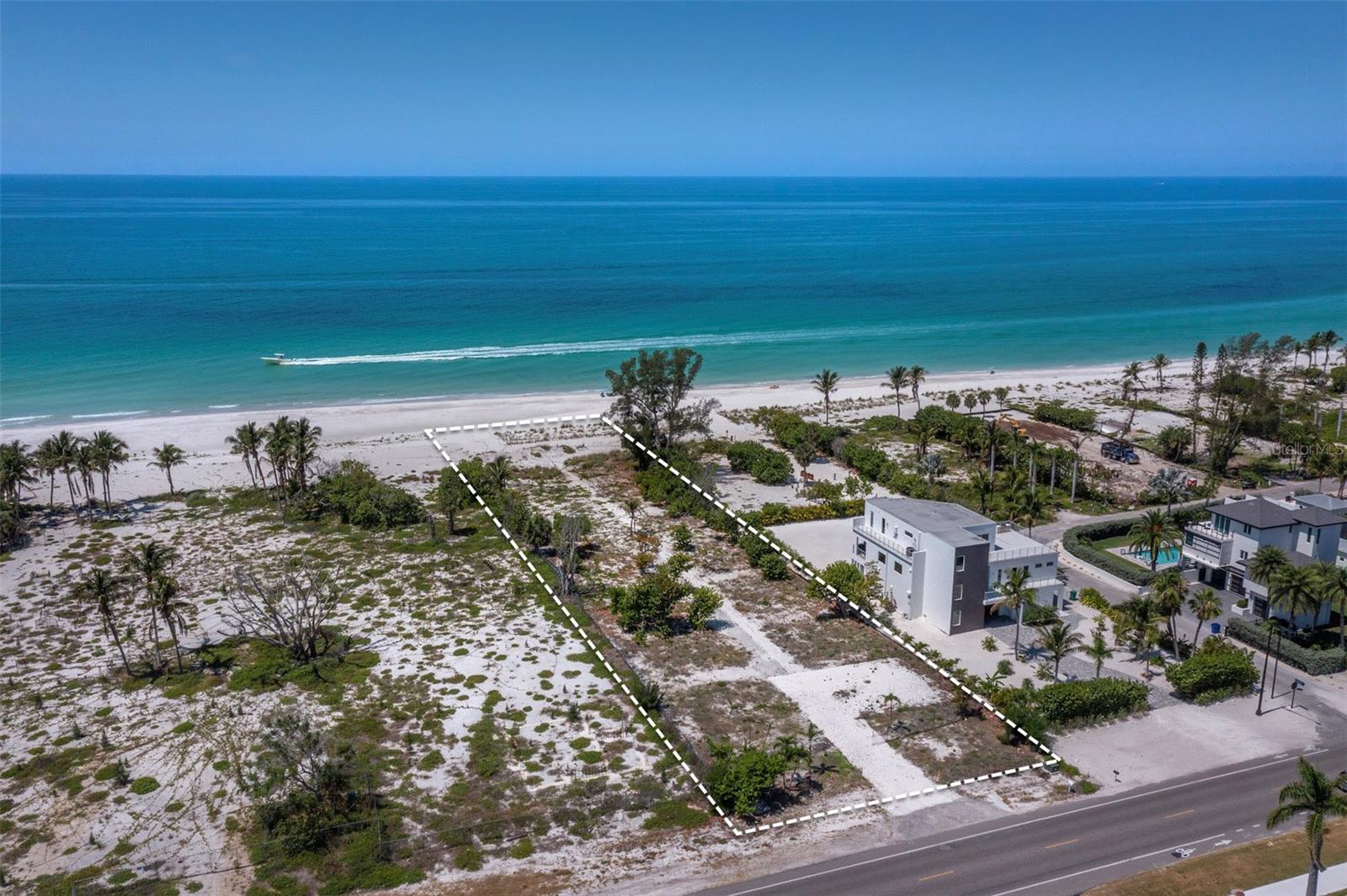 Rarely does an estate-sized Gulf-front lot of this stature become available on the northern end of Longboat Key. 6351 Gulf of Mexico Drive presents a truly exceptional 100-foot by 388-foot direct beachfront parcel — nearly 39,000 square feet of pristine Gulf of Mexico frontage. This distinguished property stands as one of the final remaining full beachfront estate-sized lots on Longboat Key, offering a rare and significant opportunity. Commanding sweeping, unobstructed views of the turquoise Gulf waters and the iconic white-sand shoreline, the site serves as a unique blank canvas for the creation of a bespoke oceanfront residence. The expansive and generously proportioned dimensions provide unparalleled design flexibility, allowing the accomplished buyer to fully realize a custom legacy property tailored to the highest standards of coastal elegance, privacy, and sophistication. Ideally situated, the property enjoys convenient proximity to the prestigious Longboat Key Club with its 45 holes of championship golf, tennis facilities, and fine dining. World-class restaurants are moments away, including The Shore, Whitney’s, Mar Vista, Euphemia Haye, and Lazy Lobster. Additionally, St. Armands Circle offers exceptional shopping and dining, while the fine and performing arts venues of downtown Sarasota are easily accessible. Positioned among notable residences yet defined by its substantial scale and immediate beach access, this parcel delivers the rare combination of exclusivity and architectural freedom. It is an offering for the discerning individual who has earned the right to create precisely what they envision — a timeless private sanctuary in one of Florida’s most prestigious coastal communities.  Private showings by appointment.