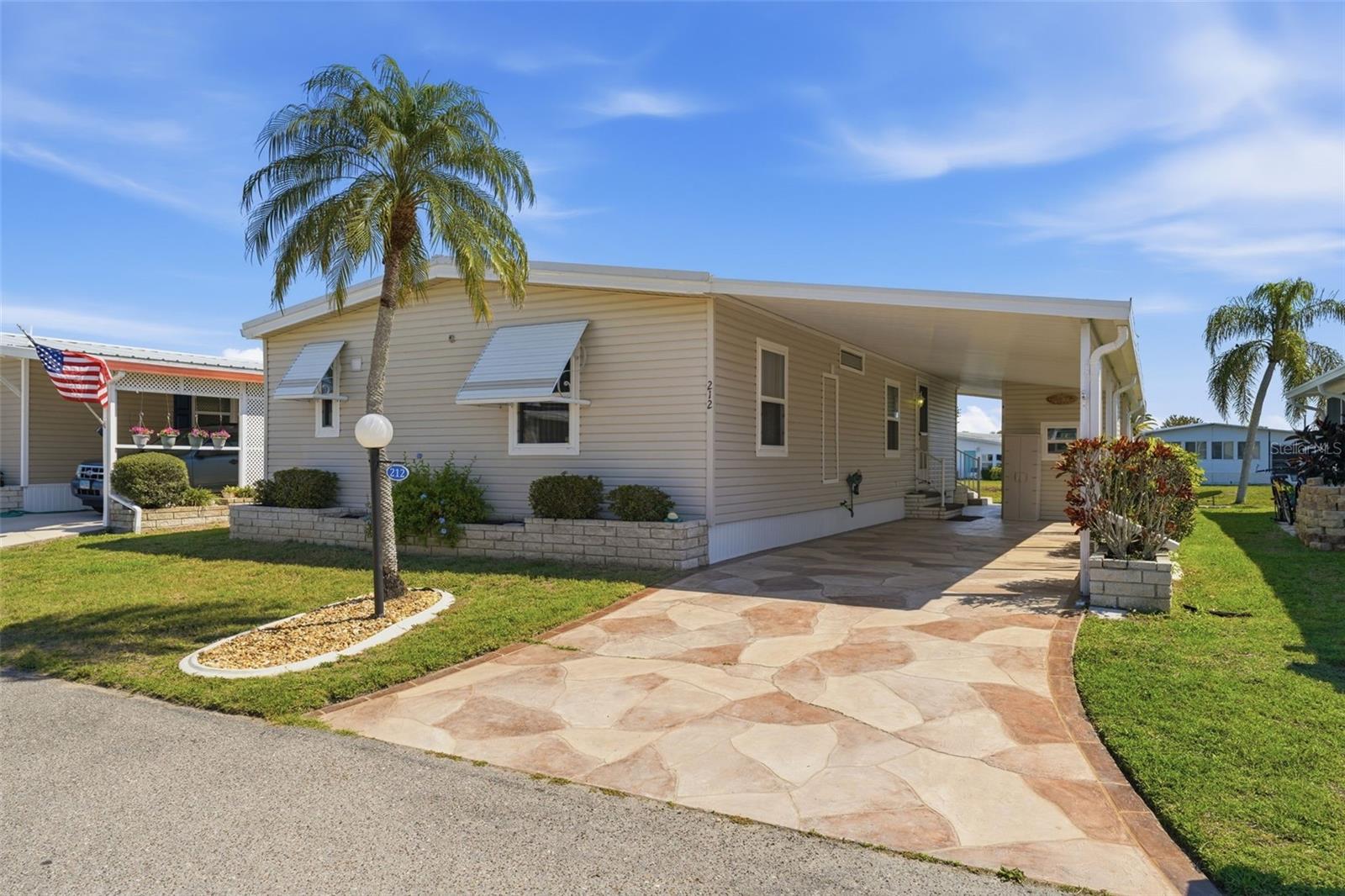 Welcome to Lazy River Village! One of the premiere (if not THE best) 55+ waterfront manufactured park in all of Sarasota and Charlotte counties! The BEST amenities, clubs, and selection of activities you will find in any co-op park in all of Sarasota county and even Charlotte County. Lazy River is located on the banks of the beautiful Myakka River. 

This 2/2 home is CUTE AS A BUG! Light-filled interior with newer windows. Well-maintained with an AWESOME WATER VIEW of Lake Cayman. Two walk-in showers (one in each bathroom). WALK-IN Closet in primary bedroom. Large Florida room with easy-to-care-for laminate flooring. Washer & dryer located in shed. Built-in storage and display space in dining area. Second bedroom has built-in desk. 

This home is the perfect seasonal place to enjoy Florida's coveted gorgeous winters and a perfect year-round home for those who love all 4 seasons of Florida. If you enjoy an abundance of activities, you will have plenty to choose from in Lazy River Village: Pickleball, tennis, bike clubs, card clubs, and pontoon boating. They even have a professional woodworking shop. A low monthly fee of $288 includes all the amenities. There are other amenities for an extra fee, such as a marina slip if your home is not located on the water. 

One of the things that makes Lazy River Village so great is its proximity to...well...everything! Be prepared to enjoy Florida's wildlife at its finest, both inside the Lazy River Village complex and at abundant state parks and nature preserves. Shopping and dining surround you in all directions. The spring training homes of both the Atlanta Braves & the Tampa Bay Rays are just a minutes away. The world-renowned Gulf of Mexico beaches are all within 30 minutes or less! 1) Englewood beach, 2) Casperson Beach (GREAT for shelling), 3) Venice Beach (shark tooth capital of the world), 4) Brohard Paw Park, 5) Nokomis beach (you've GOT to experience the weekly drum circles), 6) the island gem of southwest Florida: Boca Grande... And finally: 7) Siesta Key in Sarasota has been ranked multiple times as the number one beach in the nation and is a mere 35 minutes away. Lazy River Village offers a lifestyle that every retiree dreams of. You have the quaint downtowns of Venice and Punta Gorda--both cities are often ranked as Top 10 destinations in the country for retirement. Another local favorite, Englewood, is a cozy, fun beach town on the Gulf of Mexico. 

The residents of Lazy River Village agree: Lazy River is a community that offers it all. Don't miss your chance to see this home!