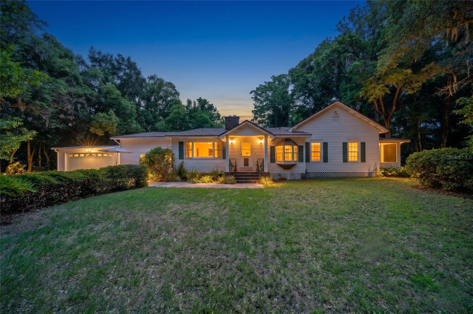 Virtually Staged. Some homes are just houses. This one has a story. Tucked beneath some of the oldest oak trees you will find in Marion County, this historic 1910 home blends ORIGINAL CHARACTER, MID-CENTURY DESIGN, PRIVACY, and functionality in a way that simply cannot be found in a cookie-cutter subdivision or a flipper-grey renovation. Over the years, the MAIN HOUSE has been thoughtfully expanded while still preserving the warmth and personality that make it feel special. Inside, you will find original character details including a room with 1910 WOOD FLOORING, vintage 70’s architectural tilework in the entrance and guest bath, and two rooms that still open onto the original 1910 covered porch overlooking the property, fire pit, and massive grandfather oaks that have stood here for generations. Modern updates include new master bedroom flooring, a soaker tub, BRICK FIREPLACE, NEW ROOF, 2021 HVAC, updated well pump, and septic drain field replacement. Additional features include a huge GAME ROOM, 2-CAR GARAGE, large covered outdoor deck, and a TREEHOUSE tucked into one of the massive centuries-old grandfather oaks. The COMPLETELY RENOVATED 1/1 GUEST HOUSE has its own fenced yard and private parking, creating flexibility for guests, extended family, workspace, or possible income potential. This listing includes the adjoining 2.45 acre wooded parcel ZONED R1/B2 for a total of 3.26 private acres with easy access to major grocery stores, pharmacies, and highways. An additional commercially-zoned frontage parcel directly on Old Jacksonville Road is also separately available for purchase under MLS OM725890. While not included in this sale, buyers may wish to explore the opportunity to combine both properties for expanded access, visibility, parking, business potential, or long-term flexibility. For more details about the history of the home, ask your realtor for the attached document featuring photos of the original house and stories from generations of occupants who have added to its history. Then come see it for yourself if you think you might want to write the next chapter.