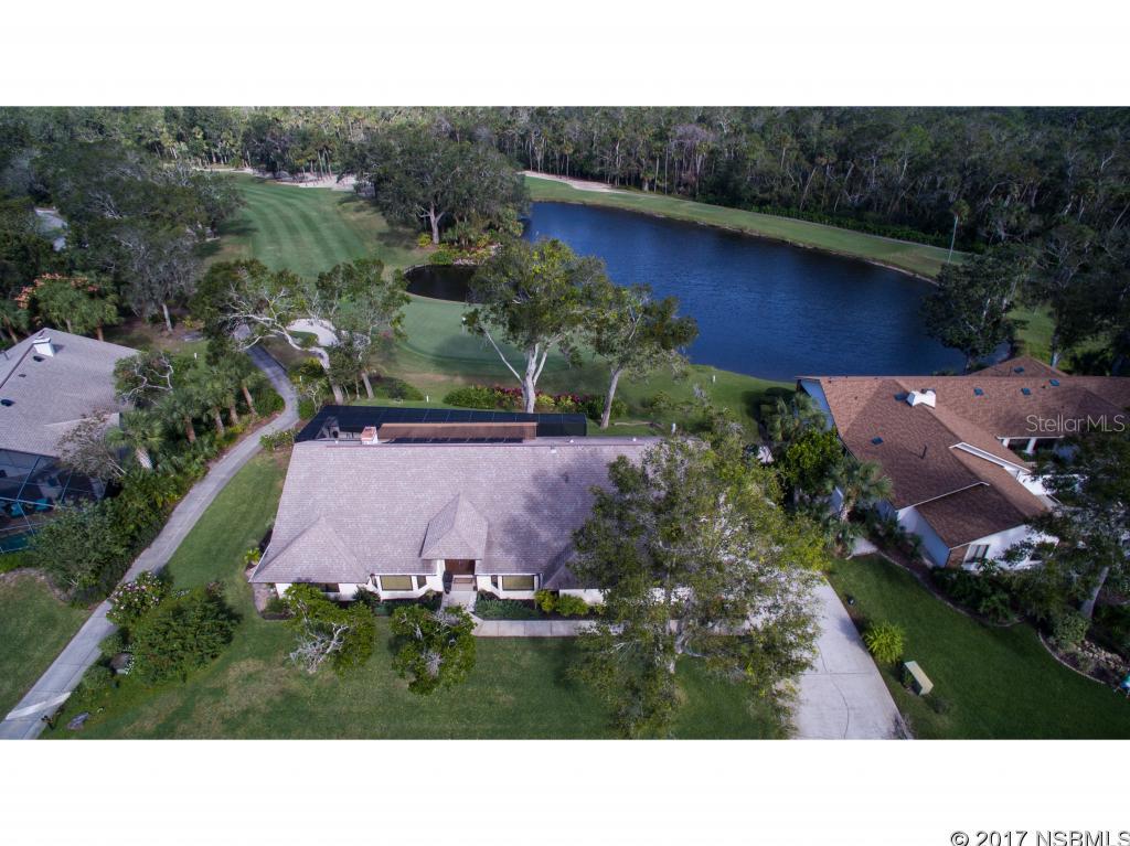 Spectacular one of a kind views of the Sugar Mill golf course & a sparkling lake & waterfall from this first class tastefully remodeled home! Paradise is yours to enjoy in this renovated home down to the studs, including custom features & top of the line upgrades throughout! Situated on a lushly landscaped lot on a quiet cul de sac on the 8th hole of the blue course, this 3BR/2.5 BA home is surrounded by several attractive pavered walls & patios that offer the most stunning views in all of Sugar Mill Country Club! Volume ceilings in all rooms, several sun tunnels & walls of windows allow natural light to flow throughout this fabulous home. Other features include custom built-in-cabinets & bookcases in living room & 3rd BR/office, Anderson windows & doors, gas fireplace, plantation shutters, alarm system & beautiful wood floors in the kitchen & family room. Gourmet kitchen features tons of new custom designed white cabinets & pantry with pull out drawers, lazy susan, quartz counters, tiled backsplash, Stainless appliances including Kitchenaid, Electrolux, Fisher/Paykel, wine cooler, under and over counter lighting & a huge island with granite counters & bar stools great for entertaining. Commercial grade gas stove & oven will delight the best Chefs! Master suite has volume ceilings, a full length walk in closet & opens to a spacious patio & park like setting overlooking the golf course. You'll love this fabulous master bath with top of the line Toto toilet, walk-in tiled shower that has a tower bath fixture with multiple heads & jets, double vanities, jetted tub & access to rear lanai & pool area. Entertaining is easy with the screened pool & summer kitchen which features granite counters, lots of cabinets & a gas BBQ grill. Oversized double garage + golf cart garage has plenty of room for tool cabinets & storage. Front office has beautiful built-in cabinets & could be formal LR/studio! Make this your dream home today & enjoy the Florida lifestyle that you deserve! ;Water: City