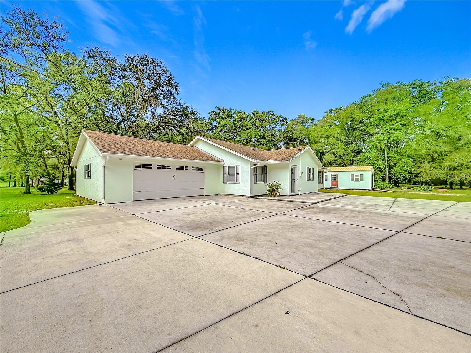 Welcome to your own private retreat on 2.21 beautifully maintained acres in the heart of Inverness. Offering an impressive 2,461 square feet of living space, this exceptional property combines privacy, functionality, and the relaxed Florida lifestyle that so many buyers are searching for.
Meticulously maintained and move-in ready, this beautiful home has been thoughtfully updated over the years, including remodeling completed around 2020, a newer 2019 roof, and a brand-new septic system. Pride of ownership is evident throughout every inch of the property.
The heart of the home is a beautifully designed kitchen featuring stainless steel appliances, a center island perfect for gathering and entertaining, a dishwasher, and a stunning custom range hood that serves as an elegant focal point. The open layout creates a warm and inviting atmosphere ideal for both everyday living and hosting family and friends.
One of the property's most impressive features is the oversized insulated garage complete with its own mini-split air conditioning system, creating a comfortable year-round space for projects, hobbies, a home gym, workshop, or additional recreational use.
Adding even more versatility is the detached climate-controlled flex building equipped with electricity, air conditioning, a built-in workbench, and dedicated storage space. Whether you're looking for a workshop, home office, studio, hobby room, fitness area, creative workspace, or additional functional space, this detached building offers endless possibilities.
The sprawling 2.21-acre homesite provides plenty of room for RVs, campers, boats, trailers, recreational vehicles, gardening, outdoor entertaining, and enjoying the peace and privacy that acreage living provides. The extended driveway and camper access make this property especially attractive for those seeking flexibility and room to spread out.
Located just minutes from historic downtown Inverness, you'll enjoy charming restaurants, waterfront dining, boutique shopping, golf courses, medical facilities, and year-round community events. Outdoor enthusiasts will love the proximity to the Withlacoochee State Trail, the Tsala Apopka Chain of Lakes, boating, fishing, kayaking, hiking trails, and Fort Cooper State Park. Crystal River and its world-famous springs and manatee encounters are also just a short drive away.
Whether you're searching for a private homestead, a place to work and play from home, or simply a beautifully maintained property with room for all your hobbies and toys, this exceptional Inverness retreat offers the space, flexibility, and lifestyle you've been waiting for.
