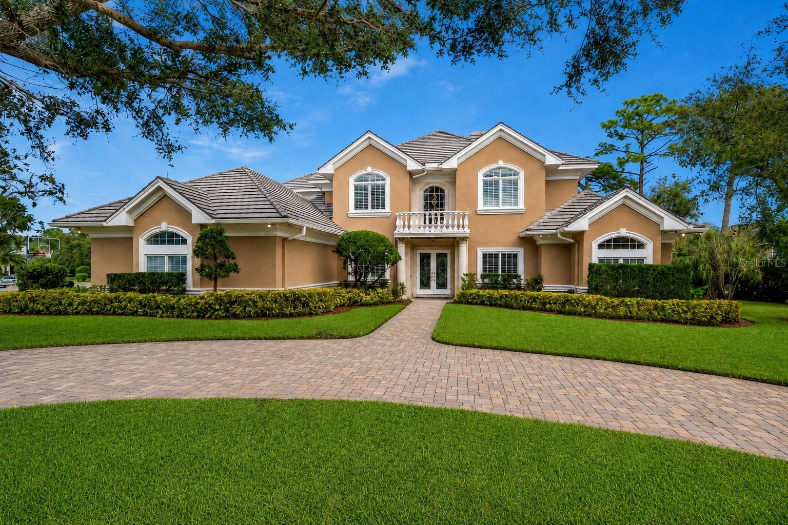 Set within the private gated enclave of Coachman Hill Preserve, this fully furnished Clearwater estate offers exceptional scale, privacy, and resort-style living, with 5,256 livable square feet on a sprawling 0.85-acre homesite. Built with concrete block construction and situated in a non-flood zone, the residence features impact-rated windows and doors, along with slate and premium metal roofing designed for longevity, durability, and enhanced storm protection. A resort-style lagoon saltwater pool and spa, screened lanai, summer kitchen, and private outdoor entertaining areas create a true turnkey Florida luxury retreat.

Designed for both refined everyday living and impressive entertaining, the interior showcases soaring ceilings, expansive architectural volume, a dedicated executive office, and 5 spacious bedrooms. The highly desirable first-floor primary suite offers a spa-like bath with dual rain showers, a soaking tub, and dual walk-in closets. Advanced smart-home capabilities and high-end infrastructure are integrated throughout, including whole-home water filtration with reverse osmosis, two tankless water heaters, and a comprehensive multi-zone camera and security system.

The newly updated gourmet kitchen is appointed with Cristallo countertops, custom cabinetry, premium tile flooring, Sub-Zero refrigeration, a gas range, dual ovens, an instant hot water tap, and an independent ice maker. The elevated design continues into the oversized laundry and utility room, featuring matching Cristallo surfaces, smart appliances, extensive cabinetry, and abundant storage. Each full bathroom is finished with luxury frameless glass doors, rain showers, and handheld sprayers.

Outdoors, experience a private resort-style retreat centered around a lagoon-style saltwater pool and spa with screened lanai. Recent pool upgrades include dual electric and gas heaters, wireless smart automation controls, color-changing pool lighting, an updated salt cell, pool pump, and related equipment. The covered outdoor living area is built for year-round hosting with a summer kitchen, built-in grill island, sit-up wet bar, fire pit dining area, weather-resistant TVs, and an integrated multi-zone sound system.

The manicured grounds are framed by more than 100 mature Areca palms and Podocarpus trees, creating exceptional privacy complemented by professional landscape lighting, an in-ground basketball hoop, and an oversized 3-car garage. Positioned in a premier Tampa Bay location, the property offers a secluded residential setting just over 5 miles from Clearwater Beach, with convenient access to Dunedin, Safety Harbor, St. Petersburg, and Tampa International Airport. A rare opportunity to own a turnkey estate combining modern infrastructure, luxury finishes, and an exclusive gated Clearwater location with only 10 homes. Schedule your private viewing today.

(Some images have been digitally enhanced for visual presentation, including lighting and TV/fireplace display. No structural elements or material property features have been altered. Buyer to verify all property details.)