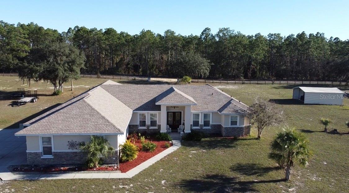 Virtually Staged. 7 acre pool estate with workshop, RV hookup, and room for animals—just minutes from boating and the Gulf. This solid concrete block 4-bedroom, 4-bath home on approximately 7 fully fenced acres offers privacy, flexibility, and true rural living with modern upgrades.

A 40x44 metal building/workshop provides excellent space for equipment, RV or boat storage, hobbies, or a home-based business. The property includes RV electrical hookup, wide-open usable land, and extensive road frontage on a 400’ x 753’ lot.

The home features a brand-new roof (2025), two newer A/C units, and a split floor plan with multiple living areas. Built with poured solid concrete block walls, the attic is spray-foam insulated and air-conditioned for improved energy efficiency. Additional updates include exterior paint (2021), added garage insulation, and mature palm trees enhancing curb appeal.

Enjoy Florida outdoor living with a screened pool and large courtyard, great for relaxing or entertaining. The acreage offers space for pasture, livestock, gardening, or expansion (buyer to verify use).

Located approximately 20 miles from the Gulf of Mexico, 8 miles to a Gulf-access boat ramp and Lake Rousseau, and about 25 miles to equestrian facilities. A rare opportunity to own a pool home on acreage with workshop, RV access, and room to live the lifestyle.