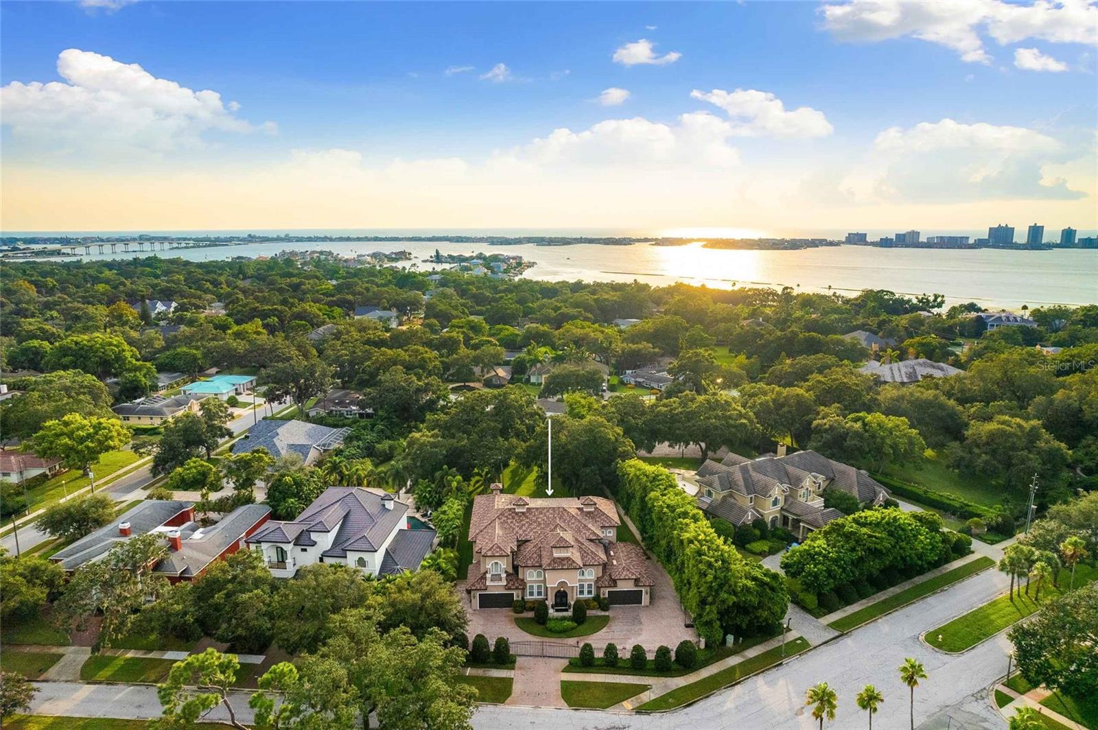 Experience unparalleled luxury in this exceptional estate, a true masterpiece of design and craftsmanship, offering over 5,500 square feet of opulent living space. Nestled behind a private gated entrance, the property welcomes you with an expansive paver circular driveway leading to a four-car garage, setting the tone for the grandeur within.
As you step through custom double doors, you're greeted by a grand foyer with soaring ceilings, exquisite, tumbled marble flooring, and a stunning wrought iron staircase, flanked by stately columns that guide you into the heart of this magnificent home. The tall ceilings amplify the sense of space, creating an elegant and sophisticated environment. The 8-foot doors enhance the grandeur of the home, offering a seamless transition between rooms and contributing to the overall feeling of luxury. This combination is perfect for those who appreciate architectural details that elevate the living experience, making the home feel both modern and timeless.
The two-story expansive family room is a showstopper, featuring a gas fireplace, floor-to-ceiling windows, elegant crown molding, and a bridged balcony connecting the East and West wings of the home and overlooking the beautifully manicured grounds & pool.
The gourmet kitchen, completely renovated in 2023, is a culinary artist's dream. It boasts a large center island, a butler's pantry, and top-of-the-line amenities perfect for both intimate gatherings and grand entertainment. The primary suite, conveniently located on the first floor, is a private sanctuary with a spa-inspired en-suite bathroom, featuring a luxurious walk-through shower and a jacuzzi tub. The recent installation of hardwood floors throughout the home adds a touch of warmth and sophistication.
Upstairs, you'll find four generously sized bedrooms and two versatile bonus rooms, ideal for a home office, gym, or media room or additional bedrooms. The second-story patio offers serene views of the lush landscape and the sparkling pool, with a spiral staircase descending to the pool patio. The 24,000-gallon heated saltwater pool is equipped with a state-of-the-art Hayward System powered by Omni Logic, allowing you to customize the lighting to create the perfect ambiance for any occasion. The outdoor kitchen is equally impressive, making alfresco dining a delight.
This estate is surrounded by a wrought iron fence in the front and block fencing in the rear, ensuring the utmost privacy. Additional upgrades include two tankless water heaters, a newly installed main gas line, and a water softener with a reverse osmosis system. Every detail has been thoughtfully curated to offer the ultimate in luxury living.