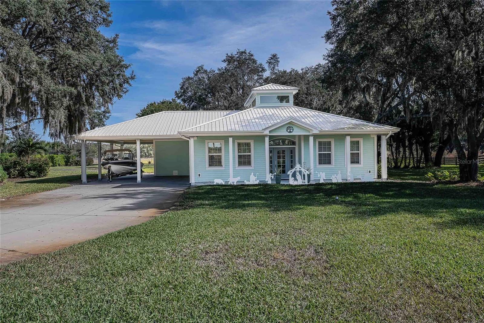 Key West–style home on more than 6 acres with beautifully landscaped grounds and travertine flooring throughout. This one-story layout offers an open floor plan, granite countertops, gas range, walk-in pantry, and extensive cabinet storage. Enhanced with Starlink high-speed internet, offering dependable modern connectivity for venue use, remote work, or ranch operations. Enjoy the screened-in saltwater pool with a new salt generator and heat pump. The property features an automatic low-voltage LED night-lighting system and a relaxing outdoor fire pit.

The oversized garage/barn includes a full kitchen, full bathroom, a spacious office, tack room, and abundant storage, plus an outdoor covered concrete pad. Irrigation is supplied by the private well.

This property is ideal for someone seeking a venue-quality setting, horse or cattle use, or a quiet country lifestyle—all while being close to town.