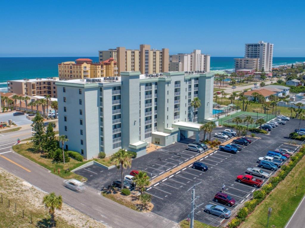 TOP FLOOR!!  This 2BR/2BA CONDO boasts AWESOME OCEAN & RIVER VIEWS plus a PRIVATE BALCONY!! MINUTES to DAYTONA BEACH INTERNATIONAL AIRPORT!!  Located in beautiful DAYTONA BEACH SHORES in SUNNY FLORIDA with EASY BEACH ACCESS across the street!!   This one owner well-maintained condo allows SHORT TERM RENTALS making it an EXCELLENT INVESTMENT OPPORTUNITY, PRIMARY RESIDENCE OR VACATION HOME!   See AMAZING SUNRISES over the AZURE ATLANTIC OCEAN!!   The primary bedroom has AMAZING OCEAN VIEWS & the primary bathroom has a tub/shower combination. Watch COLORFUL SUNSETS over the INTRACOASTAL WATERWAY/HALIFAX RIVER from the west facing windows in the kitchen & guest bedroom!! The kitchen has a convenient breakfast bar. The NEWER 40 GALLON HOT WATER HEATER assures that you & your guests can refresh with a hot shower or bath in comfort. The TOP QUALITY HURRICANE RATED SLIDING GLASS DOORS provide peace-of-mind and security as well as sound proofing.  The BEACH WALKOVER is right beside the building to access the PRISTINE "NO DRIVE" BEACH to the south or take a wonderful ride on the DRIVE BEACH to the north, giving you the BEST OF BOTH WORLDS!! Community amenities include a secured entrance and on-site management. A sparkling pool is located on the south side of the building so it gets sun all day and no sand in the pool!! There are pickleball/tennis courts, a clubroom for gatherings & bicycle storage plus extra storage for residents on each floor. You'll also enjoy the convenience of having the CLOSEST RESERVED PARKING SPACE to the main entrance! The maintenance fee includes high-speed Internet and basic cable TV in addition to water, sewer, trash, pest control & building insurance. PET FRIENDLY up to 20 LBS. Great location near shopping, restaurants, entertainment, medical centers, marinas, charter fishing, airport & more! Live the best beach life & generate great rental income when you choose!!