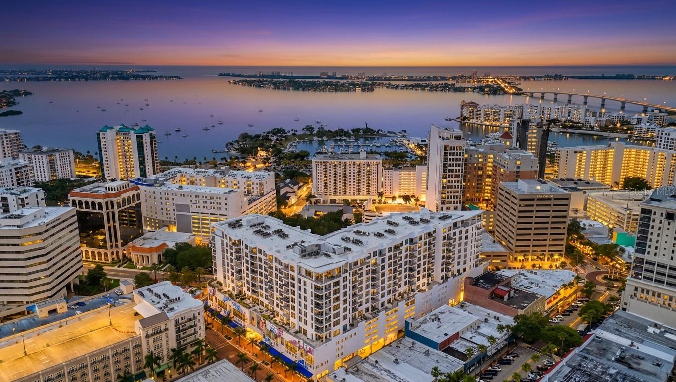 Design forward luxury at The Mark, where elevated living meets refined coastal elegance. This impeccably maintained End unit residence features three-bedroom, three and a half bath with a private office and showcases a seamless blend of sophistication and comfort, all framed by captivating Sarasota Bay views.


From the moment you enter, walls of glass invite natural light to pour into the expansive living and dining spaces, creating an airy ambiance with soaring 10-foot ceilings.  Breathtaking panoramic views of Sarasota's vibrant skyline and bay vistas from the living areas and bedrooms. Upscale custom remote-controlled window treatments allow you soft daylight with privacy when wanted. The open-concept design flows effortlessly to a generously sized balcony—accessible from both the family room and the primary retreat—offering a serene setting to enjoy morning sunrises or evening sunsets over the Sarasota Bay.


A standout feature, the glass-enclosed office provides the perfect balance of privacy and connectivity—ideal for working from home while remaining visually engaged with the main living areas.


The chef’s kitchen is both striking and functional, appointed with sophisticated European-style 2-tone cabinetry with soft close drawers, quartz countertops, and a full suite of Jenn-Air stainless appliances. Clean lines and a light, modern palette, and porcelain tile throughout enhance the home’s timeless appeal. 


The primary suite is a true retreat, featuring private balcony access, two custom walk-in closets with built-ins, and a spa-inspired bath with dual vanities, a frameless glass shower, and refined finishes throughout. Two additional bedrooms  with en-suite bathrooms provide comfort and privacy for guests.  A stylishly appointed powder bath is ideal for all of your guests and family.


Every detail has been thoughtfully curated, from designer lighting to high-quality materials, delivering a polished and cohesive aesthetic throughout the residence. The residence includes 2 premium 3rd floor adjacent parking spaces in the secured parking garage and a storage unit within the building on the same level as unit.  Quick access just 2 floors down to the amazing 5th floor amenities


Residents of The Mark enjoy world-class amenities, including a large pool deck area, 65 foot resort-style heated saltwater pool and spa, cabana areas, fire pit and lounge area, outdoor grills, state-of-the-art fitness center, club lounge with a fireplace, bar, billiards, catering kitchen, and newsroom cafe, and 24-hour concierge services—all just steps from Sarasota’s vibrant dining, shopping, and cultural scene.


A rare opportunity to own a sophisticated bay-view residence in the heart of downtown Sarasota