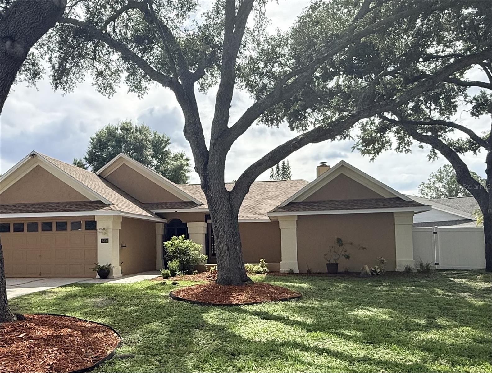 Virtually Staged. FOR RENT — Beautifully updated 3BR/2BA in sought-after Pebble Creek, New Tampa! The open floor plan creates a bright, airy flow perfect for everyday living and entertaining. At the heart of the home is an upgraded kitchen with a brand-new butcher block island—ideal for meal prep, dining, and gathering. Light-filled great room with high ceilings and a charming fireplace. Freshly painted interior in soft modern gray, gray tile in main living areas, brand-new carpet in all bedrooms. Private primary suite with king-sized space, dual vanities, soaking tub, separate shower, and walk-in closet. Spacious secondary bedrooms; renovated guest bath. Step out to the screened lanai and fully fenced backyard—perfect for relaxing, playing, or entertaining. Enjoy Pebble Creek amenities: pool, playground, tennis, pickleball, basketball, volleyball & dog park. Easy I-75/I-275 access; near shopping, dining, hospitals. Don't miss your chance to call this beautiful home yours—schedule your showing today before it's gone!