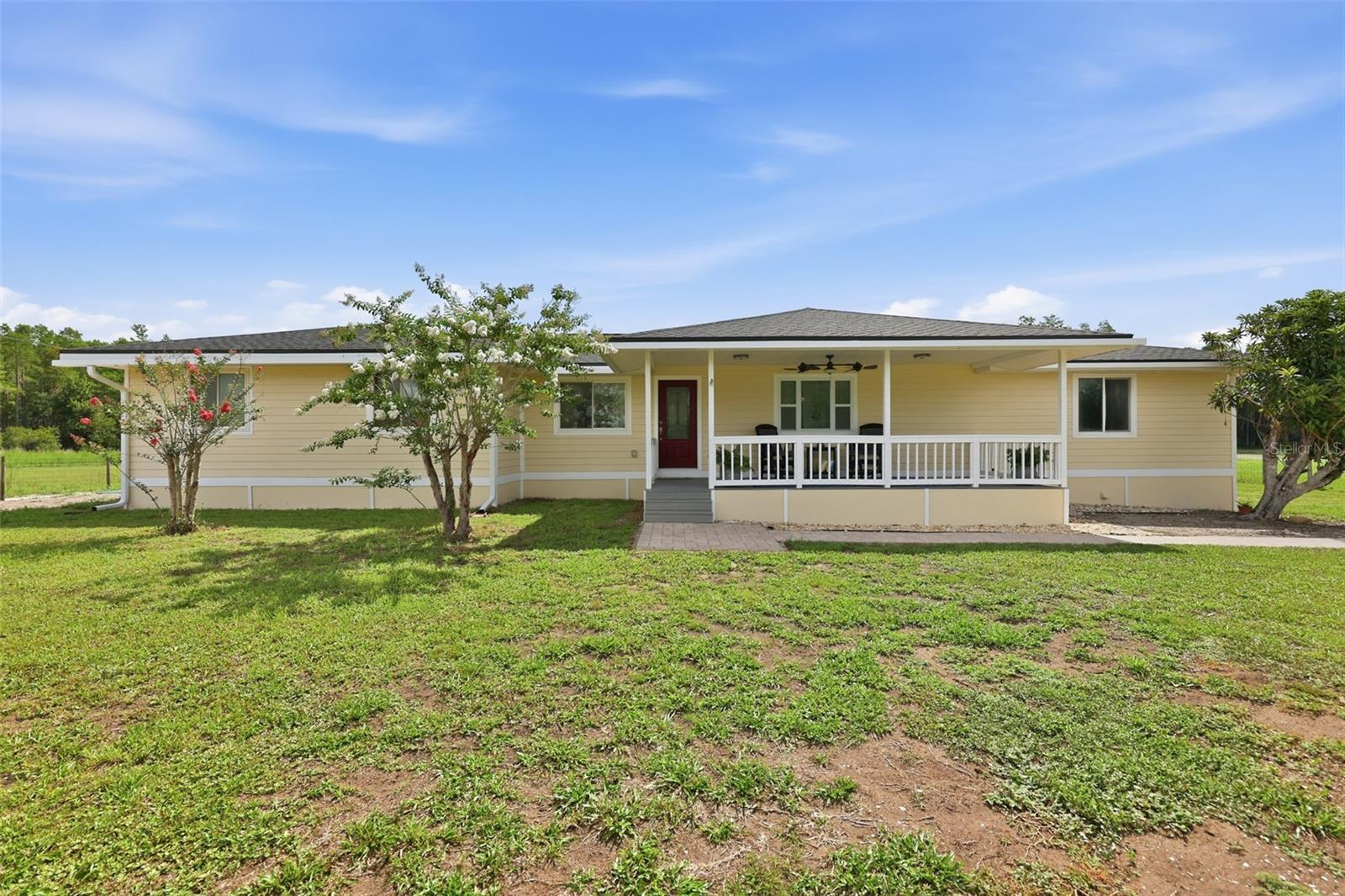 This rare property doesn't come along often. If you're looking for a property in the heart of Land O' Lakes, but want to have your own private space, then look no further. With nearly 1 acre (0.99) of land and 1452 sq feet, this 3 bedroom, 2.5 bathroom, 2 car garage with an in-ground pool is the ideal combination of space and privacy. A warm and welcoming porch greets you and is the perfect place to enjoy the sunset. As you step inside you will notice the attention to detail in this meticulously maintained home. A large living area is perfect for gathering and creating memories with family and friends. Enjoy years of relaxing by the cozy working wood burning fireplace. Envision yourself cooking fresh eggs from your own chickens in the beautifully updated eat in kitchen, and dining area. The large chicken coop and the current chickens will convey will the sale. The primary bedroom is spacious with a large walk-in closet and an ensuite that is the perfect place to unwind. There are also two spare bedrooms and an additional spare bathroom with tub. 
The entire property is fenced. There is a large pole barn that is the perfect place to park your RV or boat. Note the storage/work area with electricity in the metal container. The highlight of the backyard is the screened in Lanai and in-ground pool. Imagine outdoor living in Florida being bug free with a shaded sitting area. Many recent updated will save you time and money. Some updates include outside repainted 2026, new roof 2025, new septic drain field and tank 2026, hardwood floors installed 2026, water softener 2022, new water heater 2026, pool resurfaced 2025 and new pump 2026, Lanai rescreened 2025, new backsplash in kitchen/quartz countertop/refrigerator/range with double oven 2024. The proximity to I-75, the Suncoast Parkway, The Outlet Mall, restaurants and shopping are an added bonus. Call to schedule your showing today because this rare property won't last long.