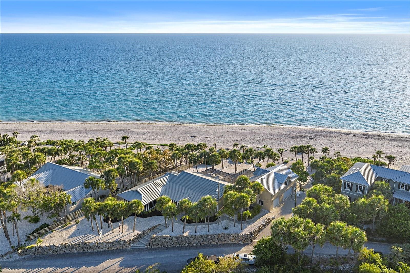To see this exquisite beach to bay residence will simply take your breath away... 

Breathtaking Gulf-to-Bay living awaits on the coveted, private north end of Manasota Key. This rare beachfront estate spans from the turquoise waters of the Gulf of Mexico to the calm shores of Lemon Bay, offering an extraordinary 155 feet of direct Gulf frontage, 155 feet of bay frontage, and nearly 299 feet of depth—creating an exceptional, compound-sized setting. The property captures sweeping, unobstructed water views, spectacular sunsets over the Gulf, and tranquil sunrises across Lemon Bay.

Cherished by the same family for almost 30 years, this legacy residence offers 5 bedrooms, 4 bathrooms, and 4,033 square feet of living space. The layout includes a 3-bedroom, 3-bath main home (3,073 sq ft) and a private, independent 2-bedroom guest apartment above the garage (960 sq ft) with its own living room, providing ideal flexibility for multi-generational family, long-term guests, or a caretaker suite. Designed to embrace the outdoors, multiple windowed doors open to the pool, beach, bay, and surrounding grounds, creating seamless indoor-outdoor living.

The main living area features dramatic cathedral ceilings, warm cypress accents, custom built-ins, surround sound, and sliding glass doors leading to the screened pool area. A bayfront dining room is perfectly framed by high-end Andersen windows to capture the morning light, while the premium kitchen enjoys direct water views from the sink, featuring solid wood cabinetry, a Thermador cooktop, GE double ovens, a GE Monogram refrigerator, two pantries, and breakfast bar seating. Outdoor living is at the heart of the home, showcasing a heated pool and an expansive 18x48 open lanai just steps from the sand.

On the bay, a private dock re-decked in 2025 (89 feet long) is fully equipped with water, electric, and a fish cleaning station, allowing for convenient boating along Lemon Bay and immediate, deep-water access through Stump Pass to the Gulf.

Beyond the premier location, the estate provides incredible peace of mind and major capital improvements. Highlights include an elevation of ~12.9 feet, a 2021 metal roof, full impact windows and doors, three newer AC systems (2018, 2022, 2023), a septic system replaced in 2016, modern PVC plumbing, and a brand-new 2025 pool cage. The fully fenced property enhances privacy while preserving the stunning, panoramic coastal views.

From your private dock, curate the perfect day on the water by heading south through Lemon Bay and tying up at local waterfront favorites, including Beachcomber Trading Post, The Lighthouse Grill, or Magnolias on the Bay for lunch, and The Waverly Restaurant & Bar for evening cocktails before continuing through Stump Pass into the open Gulf.

Located along one of the most desirable, pristine stretches of Manasota Key, this exceptional property offers a rare combination of dual waterfront scale, absolute privacy, superior boating access, and breathtaking natural beauty.

Options: Manasota Key Club offering pickleball, bocce, tennis, a community pool, fine dining, walking paths, and vacation cottages for guest rental. And Hermitage Artist's Retreat: a renowned incubator for diverse, original works across all artistic mediums, hosting global artists right on Manasota's Gulf-front campus.