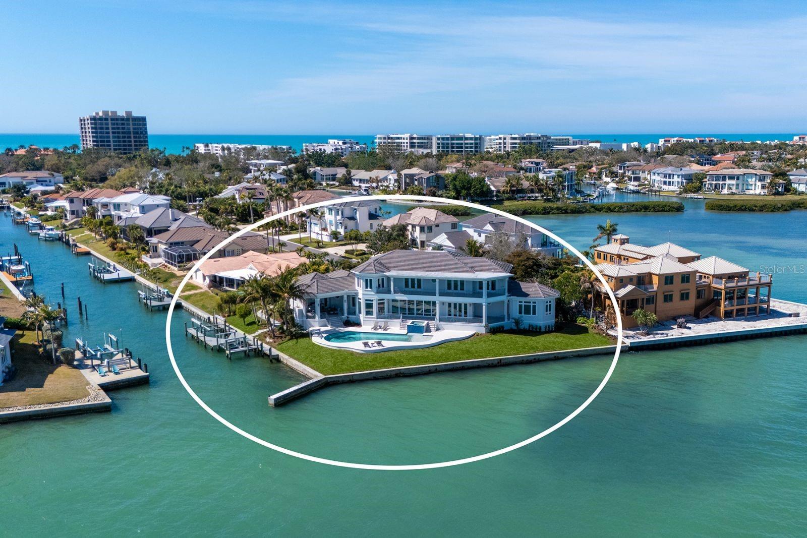 Welcome to Paradise on Longboat Key.  This coastal modern home is located on the direct bayfront with a total of 270 feet of waterfront on an oversized lot consisting of 18,290 square feet.  As you enter the home, your first view is a serene and expansive view of Sarasota Bay all the way from the Ringling Museum to Downtown Sarasota and the Ringling Bridge.  Enjoy different types of boating as the dock includes 2 jet ski lifts and a 13,000 pound boat lift.  With plenty of interior space, there are 5 bedrooms and 5 baths plus a dedicated office/den, family room and game room.  Every bedroom is filled with bay views. As an added advantage, guests have their own space upstairs that includes a kitchenette.  Outfitted with an elevator that stops at every floor, including the three car garage, convenience is just a step away.  To enjoy the views outside, there is an outdoor surround lanai with disappearing screens, fireplace and summer kitchen. Large covered terraces on both levels provide views of beautiful sunrises over Sarasota Bay and Downtown Sarasota.