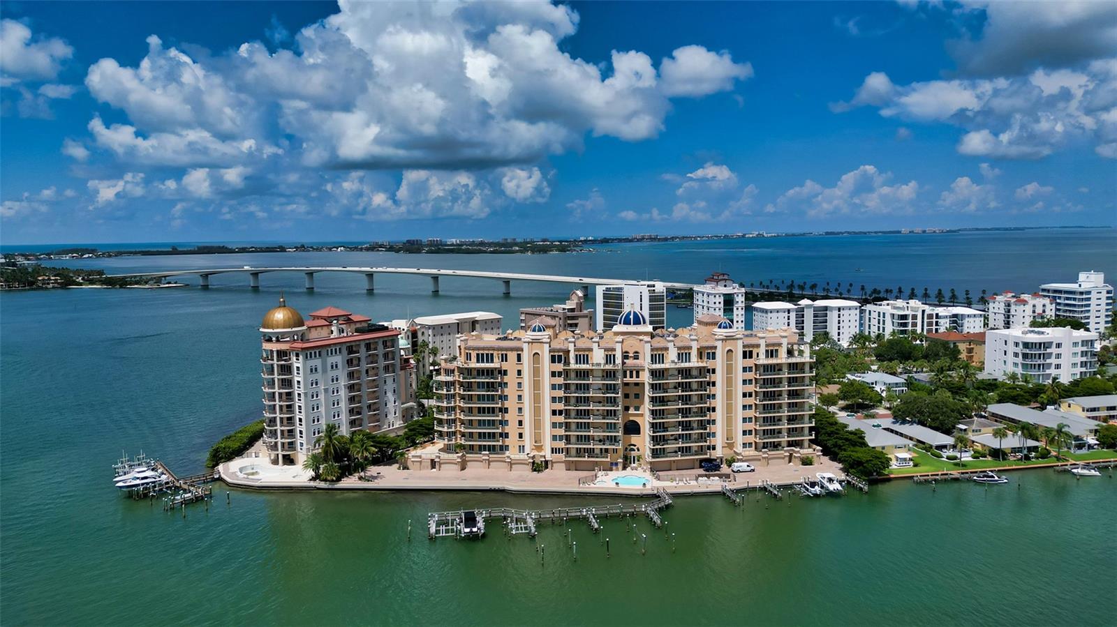 REFRESHED & MODERNIZED!  FOREVER UNOBSTRUCTED BAY & DOWNTOWN CITY VIEWS! Experience luxury waterfront living at La Bellasara on Golden Gate Point. This 7th-floor, 3-bedroom plus den, 4.5-bath residence captures breathtaking, panoramic forever views of Sarasota Bay and the glittering city skyline from every room, blending sophistication with the relaxed coastal lifestyle. A private elevator opens to a grand double-door foyer, where stone floors lead through expansive living spaces with 9–11 ft. ceilings. The main living area features rich wood built-ins and flows seamlessly into the updated gourmet kitchen—complete with custom white cabinetry, top-tier appliances, a 6-burner gas range, center island, and walk-in pantry. The open layout connects to the dining area and breakfast nook, all oriented toward the water. Step outside to the 42-ft. bayfront terrace, ideal for entertaining with its built-in summer kitchen. A separate library with custom bookcases offers a quiet retreat or optional guest space. The private primary suite features two luxurious bathrooms, dual walk-in closets, a morning bar, and terrace access for sunrise views over the bay. Two guest suites, each with ensuite baths, custom closets, and private terraces, are thoughtfully positioned for privacy. Additional highlights include a private 2-car garage with extra storage conveniently located near the elevator—offering the feel of a private home with the ease of condominium living. Community amenities include concierge services, a heated pool and spa, fitness center, theater, social and meeting rooms, and a courtesy day dock. La Bellasara is a gated, pet-friendly enclave offering luxury, comfort, and an unbeatable bayfront lifestyle. Furnishings available separately.
