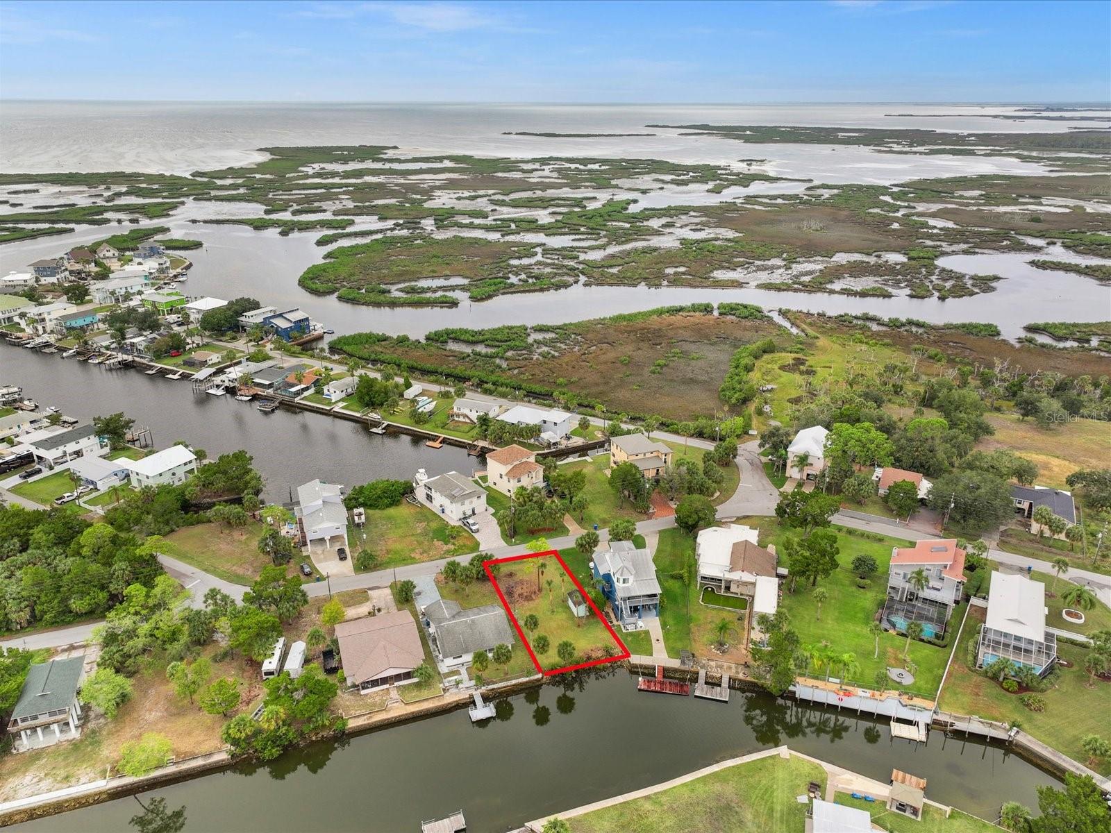 Welcome to the Gulf Coast Fishing enthusiast's dream! This remarkable waterfront lot presents a unique opportunity to create your ideal home in the serene haven of Hernando Beach. Boasting 60 feet of frontage on a saltwater canal, this property provides direct access to the Gulf of Mexico without any fixed bridges, allowing you to embark on fishing adventures with ease.

Imagine waking up to the sight of dolphins and manatees gracefully swimming behind your future home, as you cast your line for prized catches such as redfish, snook, and snappers right from your own lot. With dimensions of 125 x 60, this larger-sized Hernando Beach Direct Access lot offers ample space for crafting the perfect coastal retreat.

One of the unique features of this property is its absence of a homeowners association (HOA), opening the door to potential short-term rentals for added flexibility and income generation. The buyer is encouraged to conduct thorough due diligence and inspections, ensuring that this piece of paradise aligns seamlessly with their vision.

Situated in Hernando Beach, a tranquil coastal hamlet dedicated to the joys of recreational fishing and boating, this lot is a gateway to a lifestyle defined by the Gulf of Mexico and the Weeki Wachee Nature Preserve. While Hernando Beach may not have a traditional sandy beach, it compensates with a distinctive coastal ambiance, featuring waterfront tiki bars, marinas, fine dining establishments, seafood markets, and charming shops.

Surprisingly close to the conveniences of "civilization," you're just under 10 minutes away from US 19, where Publix, shopping centers, popular chain restaurants, Walmart, Sam's Club, and access to four major hospitals await. Furthermore, Hernando Beach is strategically positioned, being only an hour away from Tampa International Airport and a mere 90 minutes from the enchanting world of Disney.

Embrace the unparalleled Gulf Coast Fishing Homes Lifestyle that Hernando Beach offers – a harmonious blend of natural beauty, recreational opportunities, and convenient access to modern amenities. Seize this opportunity to build