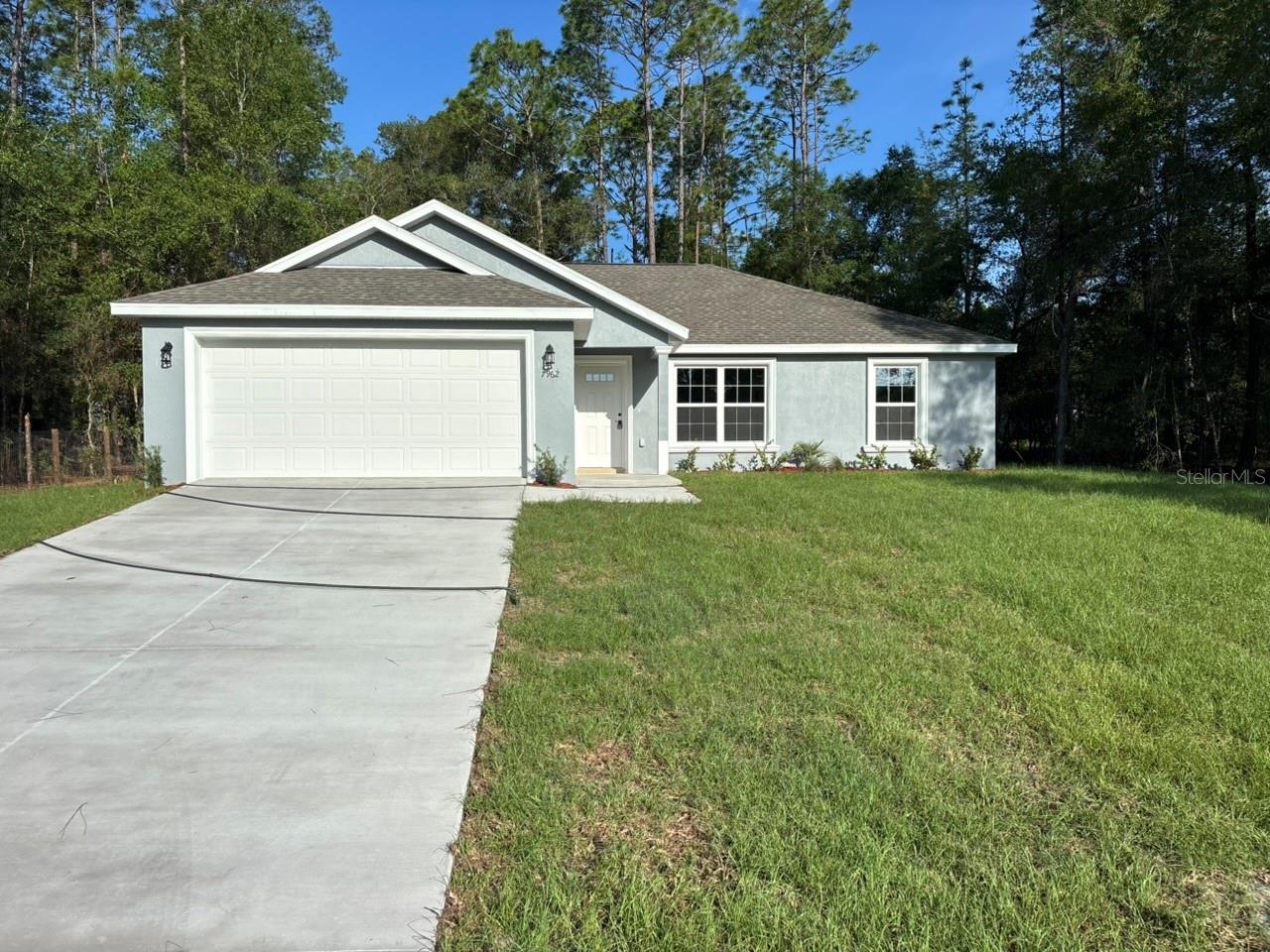 NEW CONSTRUCTION. MOVE-IN READY! This Key West Model in Citrus Springs offers 3 bedrooms, 2 bathrooms, and 1,405 square feet of well-planned living space with concrete block construction, a 30-year architectural shingle roof, energy-efficient double-pane windows, and a 10-year structural warranty. Inside, the home features vaulted ceilings in the main living area, luxury vinyl plank flooring throughout, stainless steel appliances, custom white shaker cabinets with soft-close drawers, granite countertops in the kitchen and bathrooms, and a kitchen pantry. The primary suite provides a comfortable retreat, while the open layout creates a bright and inviting space for everyday living and entertaining. Additional features include washer and dryer hookups, a covered patio, an attached 2-car garage with an opener and remotes, ownership freedom with no association fees, and a high-and-dry, flood zone X location with no flood insurance required.