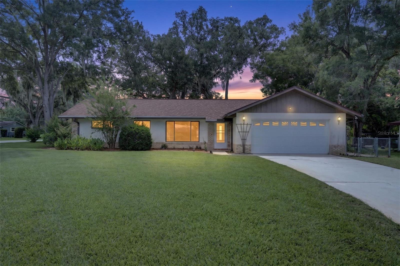 Move-in ready 3-bedroom, 2-bath concrete block home featuring a desirable split-bedroom floor plan. Recent updates include beautiful luxury vinyl plank flooring throughout, fresh interior paint, and a new roof (2023). Enjoy the spacious 20' x 13' screened porch overlooking the beautifully landscaped corner lot—perfect for relaxing or entertaining. This well-maintained home offers comfort, style, and curb appeal in one attractive package.