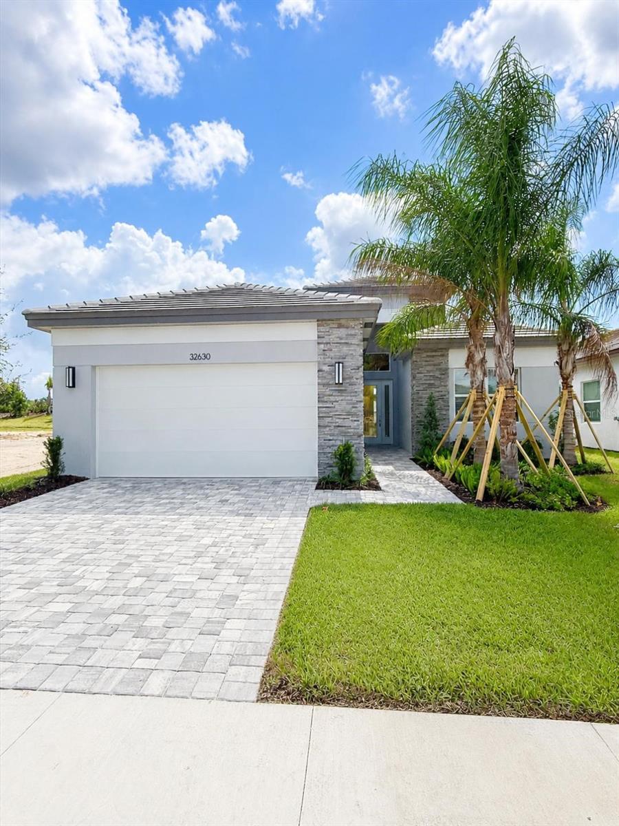 NEW Isabella Floorplan | Move-In Ready | Exceptional Value

Welcome to the all-new Isabella floorplan, at Wesley Chapel’s premier 55+ Active Community, Valencia Ridge. Offering 2,276 square feet of thoughtfully designed living space in a beautiful private homesite setting at 32630 Neroli St., Wesley Chapel, FL 33543. Priced at $639,900, this home presents an incredible opportunity with over $21,000 in savings, including lender incentives and designer upgrades.

From the moment you enter, you'll be captivated by the grand foyer featuring soaring 13-foot ceilings, leading into an expansive open-concept living area highlighted by 12-foot ceilings and abundant natural light. Elegant transom windows throughout the main living space and primary suite enhance the home's airy feel, creating a bright and inviting atmosphere perfect for both everyday living and entertaining.
This stunning residence offers 2 bedrooms, 2.5 bathrooms, a private den, and a 2-car garage, all situated on a desirable homesite with a private berm view and lush landscaping.

The gourmet kitchen is a true showpiece, featuring upgraded GE Profile appliances, including a counter-depth refrigerator, built-in gas cooktop, oven/microwave combination, chimney-style hood, and dishwasher. Designer finishes abound with a spacious cabinet pantry, Level 3 Preston Bright soft-close cabinetry, luxurious Carrara Mist quartz countertops, and a seamless quartz backsplash extending up the kitchen walls for a sleek, modern look.
Throughout the home, you'll find upgraded 24" x 24" Tranquility Coast rectified tile in Sandcastle in all main living areas, bathrooms, and the den, complemented by upgraded carpeting in both bedrooms. The primary suite serves as a private retreat with impressive 12-foot ceilings and abundant natural light.

Additional upgrades include a striking glass front entry door, upgraded HVAC system, water system pre-plumbing, and laundry room sink pre-plumbing for future convenience.
As an added bonus, this home includes all appliances, FREE blinds, a lighting package, and upgraded interior paint in the popular Drift of Mist color palette.

Originally priced at $661,862, this home is now offered at a discounted price of $639,900, when financing through GL Financial and closing with Nova Title, or when purchasing with cash and using Nova Title.
Don't miss your chance to own this beautifully upgraded, newly designed Isabella floorplan in one of Wesley Chapel's most desirable communities. Schedule your private tour today!

HOA is $349/month and will be going up to $525/month once all amenities and services are in place.
Current HOA includes lawn care/landscaping maintenance, irrigation, gated entry, in-home alarm system monitoring, maintenance of common areas, and Full Time Social/Lifestyle Director

Racquet Club is officially open – offering Pickleball, Tennis & Bocce with a Pro Shop & Instructors!
Temp Community Center Houses are open and equipped with a full gym and a space for social activities, events, and clubs!
Full time Lifestyle Director coordinates events & socials each month.
29,000 SQ FT Clubhouse is well underway with an estimated completion date of early 2027.