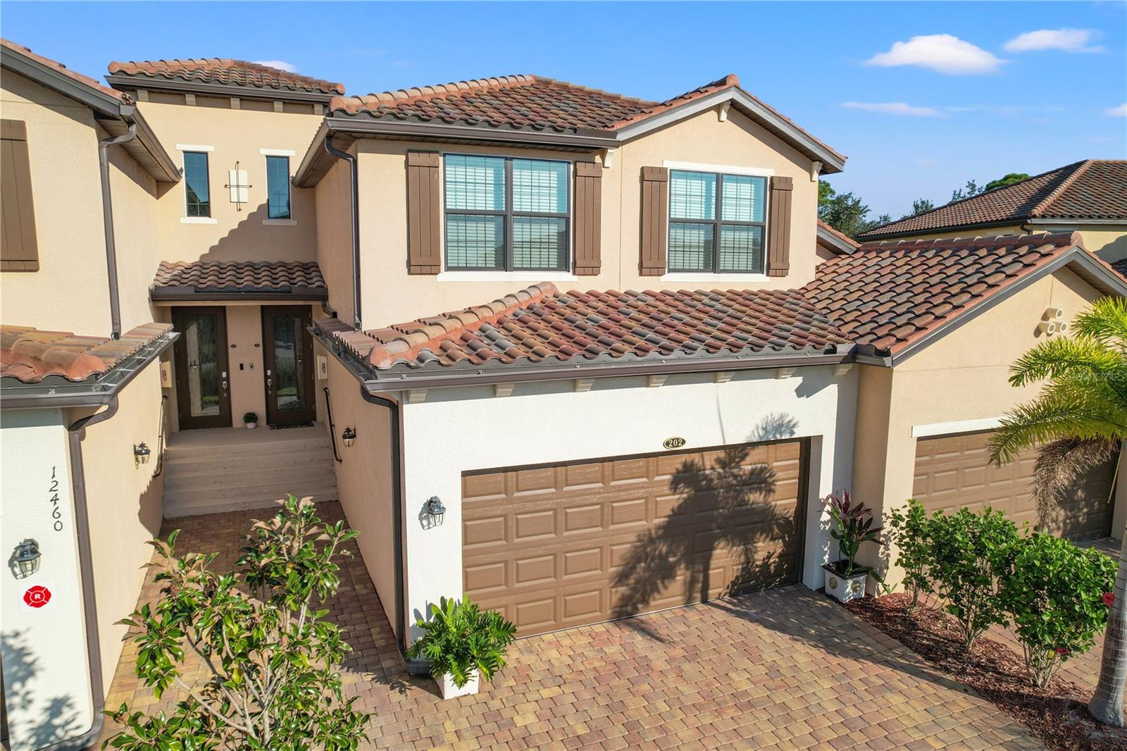 Don't miss the opportunity to own this high-value property at an exceptional price! Welcome to GRAN PARADISO, a Tuscan-inspired RESORT STYLE gated community in Venice, SW Florida, with 5* Amenities! This stunning 3 beds/ 2 baths/ 2-car garage Coach home, built in 2021, is offering features that redefine comfort and elegance. The kitchen is a chef's dream, featuring ample cabinet space, quartz countertops, stainless-steel appliances, custom backsplash, under kitchen lights, and an island for a casual dining. It opens to spacious Living and Dining room, creating a perfect space for entertaining friends and loved ones. The master suite is a true retreat, boasting a master bath with a luxurious Standing Shower, and split vanities. Two additional bedrooms and a bathroom with tub ensure space and privacy for family members or guests. This home boasts porcelain tile and luxury vinyl floors, walk-in closets in every room, crown moldings, extra storage spaces, and IMPACT WINDOWS for your peace of mind and safety. The EXTENDED 2-car GARAGE also offers extra space, perfect for a golf cart, bikes, workshop, or additional storage. Open the sliding doors, leading to the screened covered balcony with a picturesque lake and preserve view, offering a serene privacy and providing the perfect backdrop for outdoor relaxation. Gran Paradiso resort style amenities include Clubhouse with billiard and game rooms, large heated pool with jacuzzi, fitness center, sauna, steam room, tennis courts, pickleball, playground and more. Enjoy nature preserves and lakes, miles of sidewalks for walking/biking and wildlife! Don’t worry about cable and internet, lawn maintenance and irrigation, Maintenance Exterior and exterior pest control - they are included in the HOA fee. *PRIME LOCATION – just minutes to the most beautiful sandy beaches of SWF, shopping, dining, fishing, boating, golfing, recreational parks, Venice historic downtown, new Wellen Park Downtown, the new Atlanta Braves Spring training facility, new COSTCO and everything Southwest Florida has to offer! This is not just a home, it's a lifestyle. Schedule your showing today and envision your future in this remarkable home!
