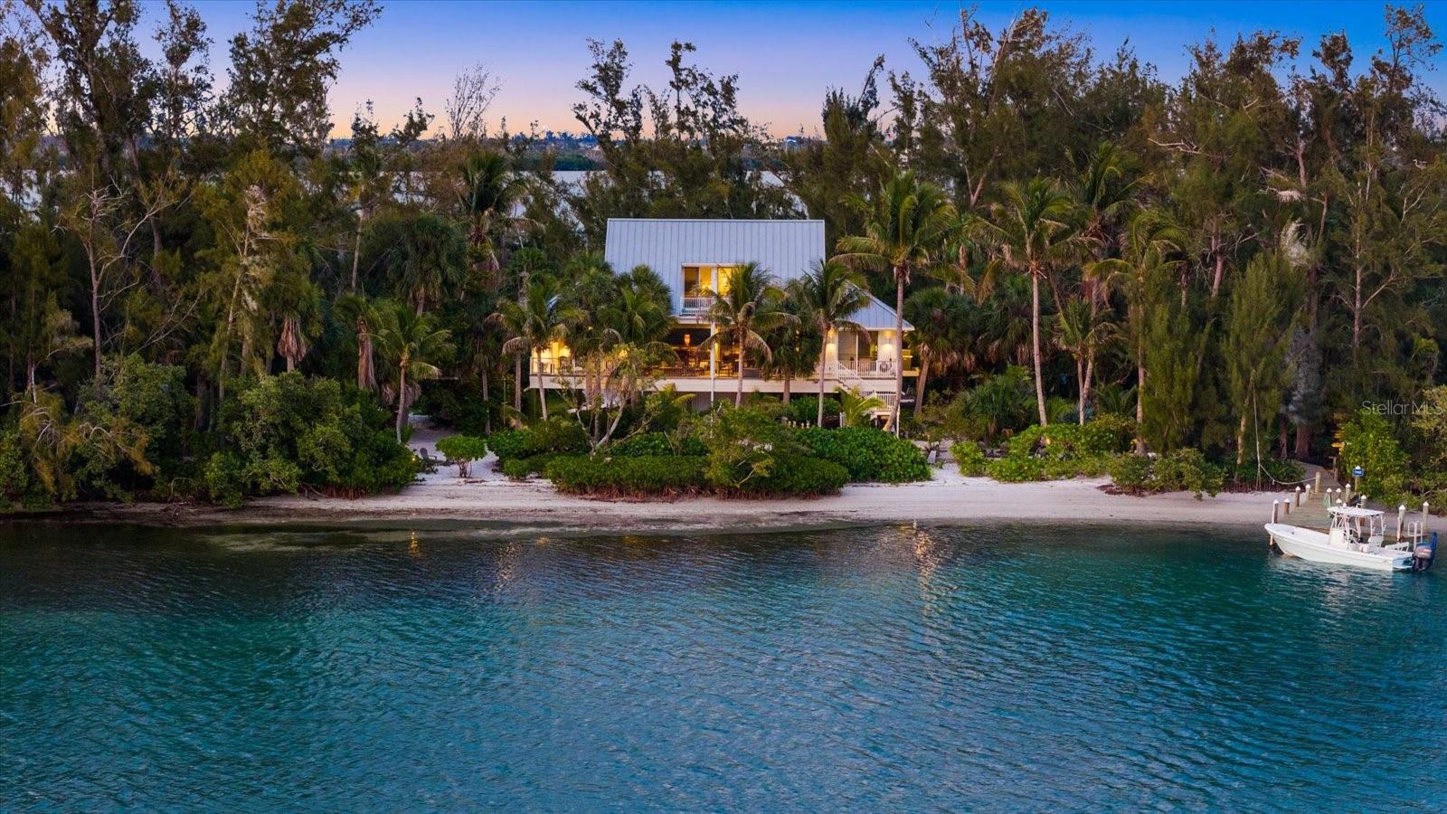 Private island living on Jewfish Key, one of eight homes, accessible by boat only. This rare offering presents a lifestyle few will ever experience: a secluded island sanctuary surrounded by the turquoise waters of Longboat Pass and the Gulf Coast’s natural beauty. An address like this comes up for sale about once a generation. 7143 La Lenaire is on the market for the first time in more than two decades.

The home is a custom built, over 2,700 square feet of living space designed to embrace panoramic water views and effortless indoor-outdoor living, four bedrooms and four baths, finished in 2011 on a 1.24-acre titled lot with roughly 300 feet of water frontage. From the island you are minutes by water to Longboat Key, St Armands Circle, and Anna Maria Island.

Every room captures breathtaking western-facing vistas, creating a constant backdrop of sparkling water, coastal breezes, and unforgettable sunsets.
The main living areas open onto covered outdoor space and frame the sunset over the intercoastal waters, and the evening light fills the rooms. It was built to handle a quiet weekend or a full house of guests.

The private deep-water dock provides immediate boating access to Sarasota Bay, the Intracoastal Waterway, Longboat Key Pass, and the Gulf of Mexico, making this a true boater’s paradise.

Jewfish Key is a hidden gem spanning approximately 38 acres, offering a level of privacy and tranquility rarely found along Florida’s Gulf Coast. Surrounded by pristine shoreline, sandbars, native wildlife, and crystal-clear waters, the island delivers an unmatched blend of exclusivity and natural beauty while still being conveniently located near Longboat Key, Anna Maria Island, and Sarasota’s world-class dining, shopping, and entertainment.

Whether used as a private family compound, luxury waterfront getaway, or one-of-a-kind investment opportunity, 7143 La Lenaire Drive represents a truly irreplaceable island lifestyle.

Turn Key - Furnished.