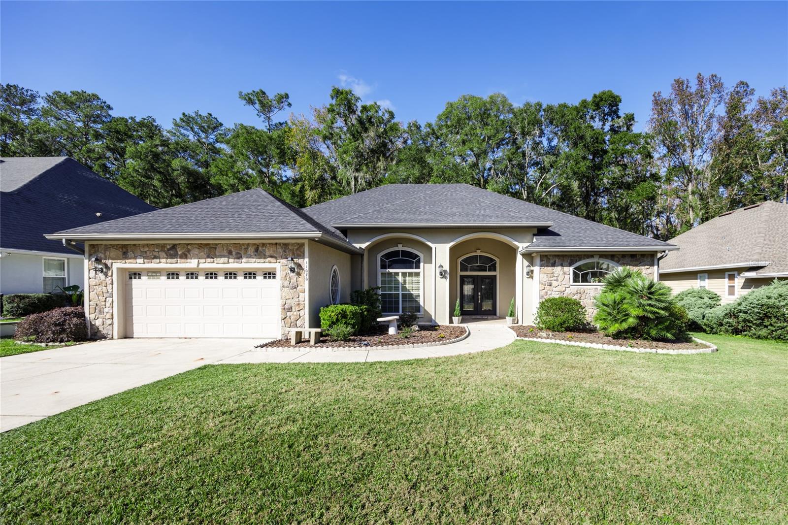 Nestled in the back of the highly desirable Turkey Creek community, this beautifully maintained 3-bedroom, 2-bath home offers the perfect blend of privacy, nature, and convenience. Backing directly to San Felasco Hammock Preserve State Park, you'll enjoy peaceful views, abundant wildlife, and frequent visits from deer right in your own backyard—all while being just minutes from shopping, dining, and an easy commute to Gainesville or Alachua.

From the moment you arrive, the home's exceptional curb appeal and welcoming presence set the tone. Step inside to discover an open and airy floor plan featuring soaring ceilings, abundant natural light, and custom built-in shelving that adds warmth and character to the spacious living area. The living room flows seamlessly into the formal dining room, accented by elegant tray ceilings and hardwood flooring that extends through the dining area and hallway.

The well-appointed kitchen shines with beautiful cabinetry, granite countertops, a newer GE refrigerator (2025), and a breakfast bar overlooking the screened lanai and sparkling in-ground saltwater pool. Whether you're entertaining guests or enjoying a quiet morning coffee, this space is designed for everyday comfort and enjoyment.

The oversized primary suite serves as a private retreat, complete with a flexible sitting area perfect for a nursery, home office, or reading nook. French doors lead directly to the screened pool lanai, creating a seamless indoor-outdoor connection. The luxurious primary bath features a separate garden tub, walk-in shower, and ample space to unwind.

Additional highlights include three sets of French doors—two opening to the lanai—an indoor laundry room, newer carpet (2023), custom built-in cabinetry, and a beautiful granite fireplace. The screened pool area provides the perfect setting for year-round Florida living, with a new Pentair VSF 1.5 pool pump installed in 2024 and a Jandy saltwater system added in 2023.

Major updates provide peace of mind, including a roof replacement in 2020. Utilities are provided by the City of Alachua for electric, water, sewer, and garbage, with GRU gas service for the furnace and fireplace. Cox internet service is available, with fiber internet access in the area.

If you've been searching for a move-in-ready home that offers natural beauty, thoughtful updates, and an unbeatable location, this Turkey Creek gem is one you won't want to miss.