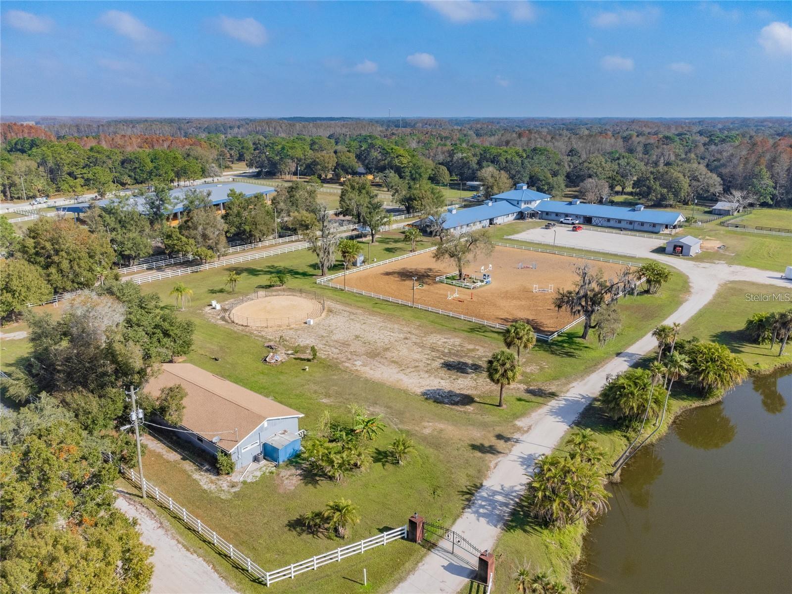 Sold with adjacent parcels 8.22 acres pin u-17-27-17-001-000000-11670.0, and 10.22 acres pin u-17-27-17-000000-11710.0 (32.26 acres total). Thirty-two acre (mol) equestrian training facility in Keystone, Odessa. The 17,000-square-foot stable is concrete block construction and has a total of 38 stalls. The two barn aisles are separated by a central common area that includes tack rooms, restrooms, laundry room and break room/lounge area that remain comfortable year-round due to central heat/AC. There is also a 2,200-square-foot loft area for storage. Separate aisles of the barn has its own office/owner’s tack room, feed room, three wash racks and a 250-square-foot tack room complete with wall-mounted saddle racks and bridle hooks. Both the men’s and women’s restrooms are handicap accessible. Spacious lounge available with kitchen area and is fully air conditioned. LED lighting down each aisle, in each wash rack and all 38 stalls. The 3.5-ton AC was installed in 2019 with all new ductwork. All old insulation was removed and replaced with rodent-resistant TAP insulation.Also included is a 2,000-square-foot metal shop building. The 31,000 square-foot covered arena has a 4” clay base. The lighted jump field can easily accommodate a full course of jumps, and a new drainage pipe has been installed under the driveway to empty standing water into the beautiful pond. Three-phase electrical that powers the pump that irrigates the jump field with the pond water through 4 commercial grade Rainbird sprinklers is the latest improvement to this property. All paddocks have a separate water line and spigot. 2,000-square-foot duplex, remodeled.