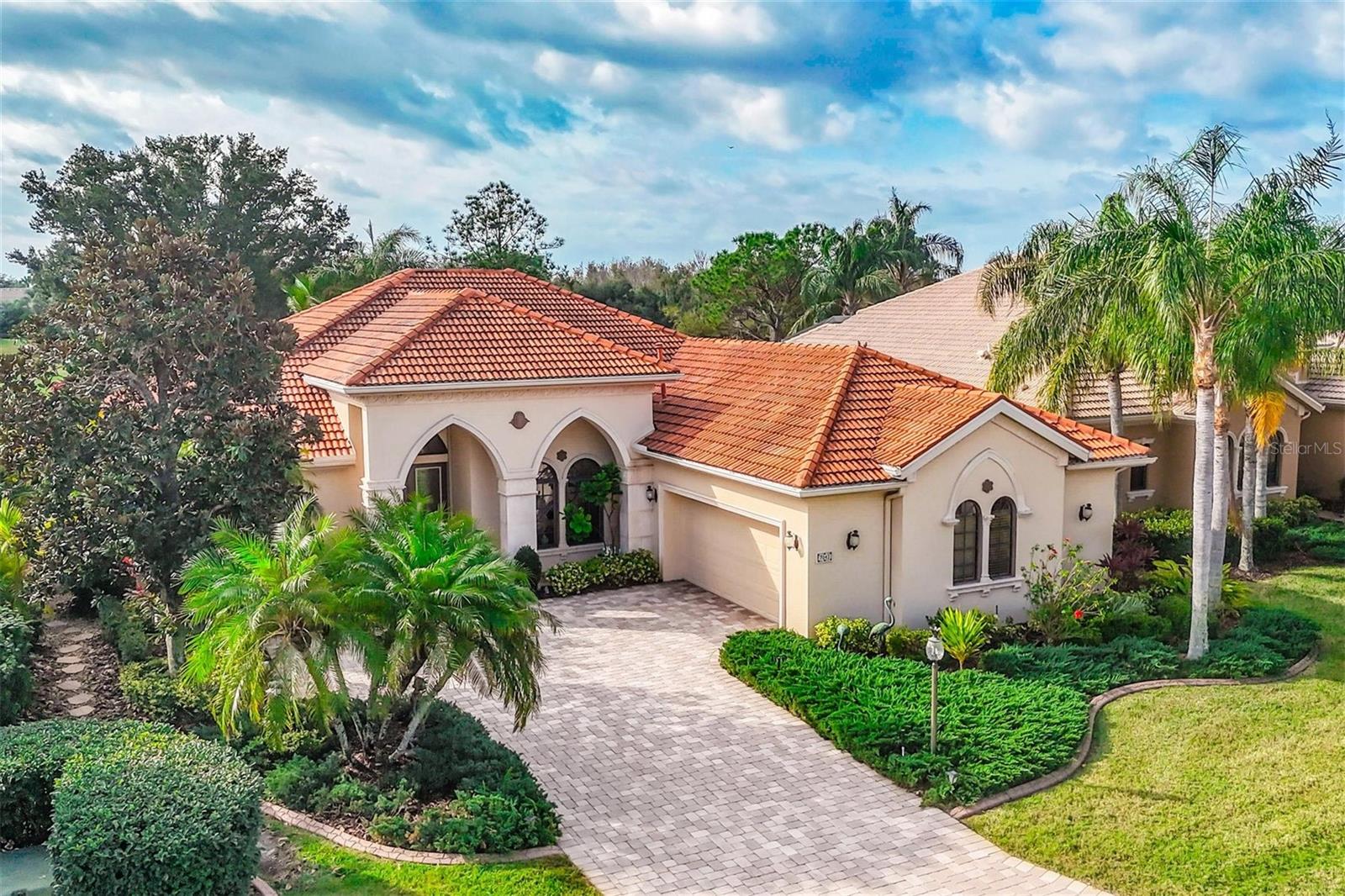 7042 Vilamoura Place is a distinctive single-family home located in the highly desirable, maintenance-free Vilamoura community within the Lakewood Ranch Country Club.  This is located in the award-winning master-planned community. Built in 2004, this Spanish Mediterranean residence sits on beautiful golf course lot. Over 10,000 sq ft of land, fronting the championship golf course, offering serene preserve views and the coveted Southern exposure. The spacious home encompasses about 2,879 sq ft with an open floorplan, 2 bedrooms, a den and 2.5 bathrooms. The owner currently uses the 3rd bedroom as a den.  They will credit the buyer 4,000.00 to add the closet.
 The custom features include a chef’s kitchen with center island, dual walk-in pantries, and wood cabinetry. Its design offers a breakfast bar and a morning room with aquarium glass.  The formal living and dining rooms have high ceilings, transom windows and crystal chandeliers. The owner's suite has separate vanities, 2 closets and the continued distinctive European flair that is throughout the residence. The den offers amazing views and has built-ins. It could easily become a 3rd bedroom.  The 2nd bedroom is en-suite. Outdoor living is a highlight with a screened, heated pool and direct access to the powder room. It also includes an oversized 2-car garage with an air-conditioned storage room.  An owner enjoys the amenities of a gated golf community with proximity to shopping, dining, top-rated schools, and Florida’s Gulf Coast beaches.  There is an optional golf membership with access to 4 courses, tennis and pickleball, dining and social activities as well as a fitness center.