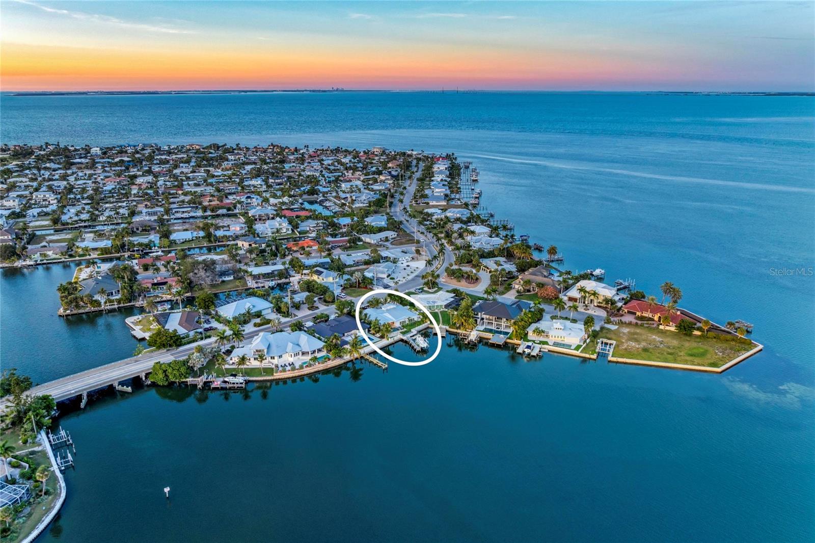 Welcome to coastal luxury living in the highly coveted Key Royale neighborhood of Holmes Beach. This fully remodeled 3-bedroom, 3.5-bath waterfront home is a rare find—offering breathtaking views, modern upgrades throughout, and direct access to Tampa Bay and the Gulf of Mexico.

Situated on a tranquil south-facing cove along the Intracoastal Waterway, this property provides both stunning scenery and natural protection. Step inside to an open, airy floor plan featuring all-new wood flooring, new interior and exterior doors, new windows with shutters, and exceptional craftsmanship at every turn.

The chef’s kitchen is a true showstopper, showcasing top-of-the-line Thermador appliances, custom cabinetry, and a spacious layout designed for effortless hosting and everyday living. The primary suite is a retreat of its own with dual walk-in closets and a beautifully updated ensuite bath. The second bedroom functions like a second primary, offering a generous bedroom space and its own private ensuite bathroom—ideal for guests or multi-generational living.

Outdoors, the home transforms into a private waterfront paradise. Enjoy a saltwater pool and spa, a full outdoor kitchen, and your own putting green—all overlooking sparkling water views where dolphins are frequent visitors. Boaters will appreciate the 16,000-lb boat lift, deep water access, and plenty of side-yard space for additional toys, including a 50-amp RV hookup and room for a boat or trailer.

With luxury updates, protected water, and unparalleled views, this is Florida waterfront living at its finest!