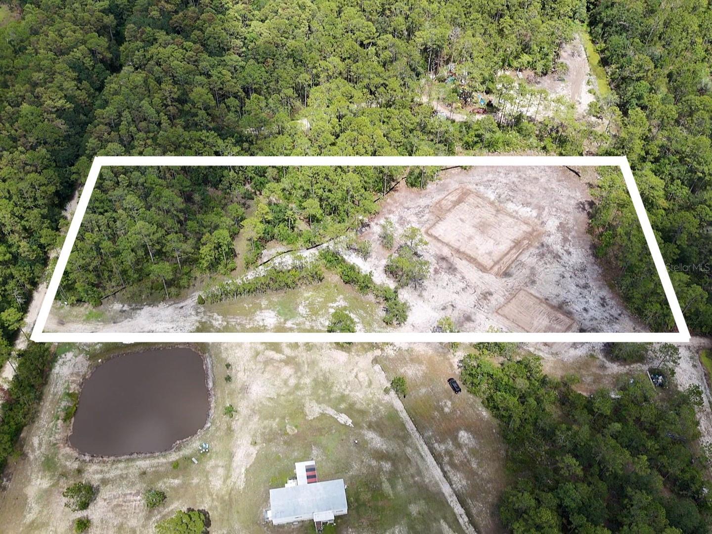UTILITIES TO BE INSTALLED SOON! WATER AND ELECTRIC AVAILABLE! HUGE PRICE DROP!! Now is your chance to take advantage of building your custom dream home on a CLEARED vacant lot in New Smyrna Beach, Florida! Zoned A-1 for residential and agricultural. 5 acres of cleared, tested, permitted, dirt filled, utility-ready land - primed for someone to come in and just build a home with option to add warehouse/workshop. Both areas for home and warehouse with plans have been dirt filled and raised. With 330 feet of frontage, the driveway to the back of the lot has been leveled off and brings you to the huge open canvas to customize your ranch style home. Internet was just installed nearby. Electric and water nearby. Pond is partially owned by neighbor. Jump on this rare opportunity to be tucked in a secluded area just minutes to New Smyrna Beaches, dining, shopping, and entertainment.