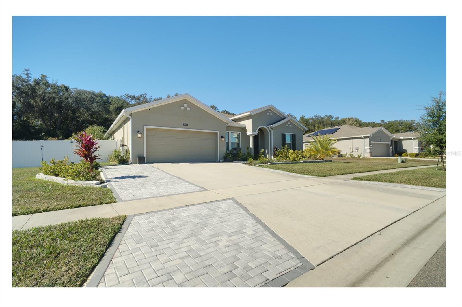 Modern Luxury Meets Mount Dora Charm Discover the perfect balance of elegance and ease in this stunning Inverness model. Boasting 2,909 sq. ft. of bright, open-concept living, this single-story sanctuary features soaring 9’4” ceilings and expansive windows that bathe the home in Florida sunshine. At the heart of the home, a gourmet kitchen shines with an oversized quartz island—a natural gathering spot that flows seamlessly into the living areas and onto the upgraded hardwood flooring. The thoughtful 3-way split plan ensures ultimate privacy, offering a secluded Master retreat with "his and her" closets, a dedicated guest suite, and a versatile flex space perfect for your home office or library. Outside, the lifestyle continues with enhanced curb appeal and a widened driveway. Nestled in a premier gated community, you’re just steps from a resort-style pool, fitness center, and pickleball courts. With Publix right outside the gate and the charm of Downtown Mount Dora minutes away, you have effortless access to the 429, Orlando, and Disney. Your Central Florida lifestyle starts here. Schedule your private tour today!