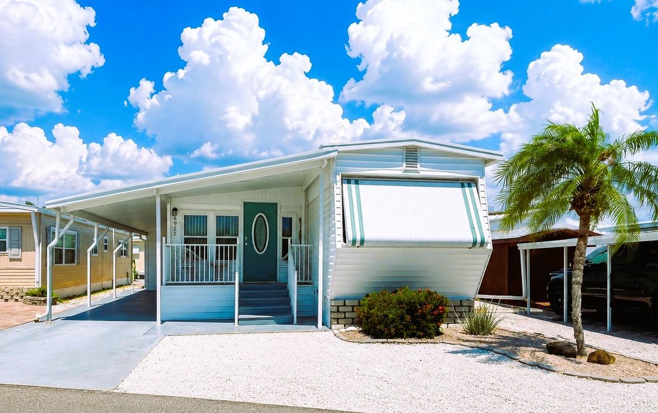 This beautifully updated and meticulously maintained furnished home offers the perfect blend of style, flexibility, and peace of mind—all in an ideal location near Sarasota Bay.

One of this home’s most unique and desirable features is the versatile sitting room adjoining the primary bedroom through elegant French doors. Open the doors to create a spacious, luxurious primary suite retreat, or close them for added privacy. With its own separate entrance, this flexible space easily functions as a third bedroom, office, den, or guest suite.

Designed with entertaining and hosting in mind, the home offers exceptional sleeping flexibility with a pull-out loveseat in the sitting room and a queen sleeper sofa in the living room—creating up to four separate sleeping areas for visiting family and friends.

Sold beautifully furnished with tasteful coastal décor throughout, this elevated home is move-in ready and packed with upgrades, including new windows (2025), new ductwork 2025 and AC 2021, new carport, new porch rails, and new roofing over approximately three-quarters of the structure 2025. Major appliances—including refrigerator and kitchen appliances, washer, dryer, and water heater—have all been replaced within the last two years.

Enjoy Florida living from both the covered front porch and the private back deck, perfect for morning coffee or evening relaxation.

Located in Trailer Estates, a Special Park and Recreation District governed under Chapter 418, Florida Statutes, residents own their land, with no lot rent, CDD, or HOA fees. The annual park tax covers cable, high-speed internet, trash pickup, fire and rescue services, and access to outstanding amenities, including a marina with rentable boat slips, private beach, pool, hot tub, fitness center, shuffleboard, bocce ball, pickleball, woodshop, and nearly 60 active clubs and social events. Experience one of Sarasota Bay’s most vibrant and welcoming 55+ communities.