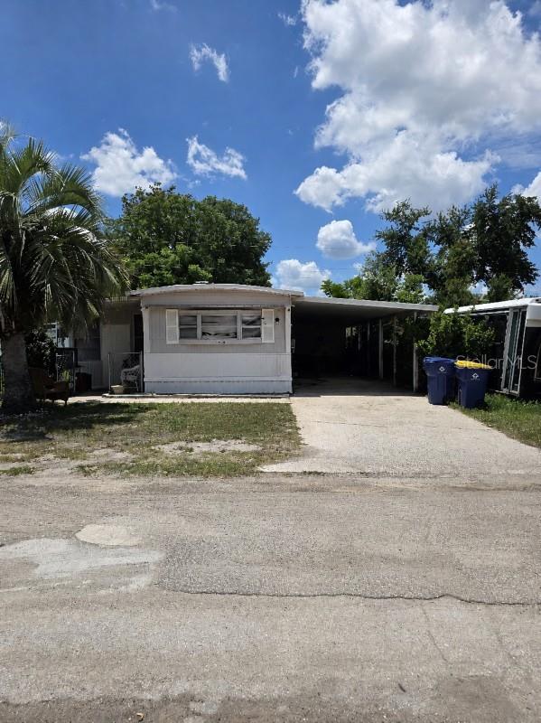 Opportunity awaits with this 2-bedroom, 1-bath mobile home offering 564 sq ft of living space. Features include a large attached utility shed, covered carport with space for up to 3 vehicles, laminate and carpet flooring, and a metal roof. The property is serviced by well and septic systems, and the home has a functional HVAC system along with a newer refrigerator and stove. Interior updates are needed, providing a great chance to add your personal touch and build equity.